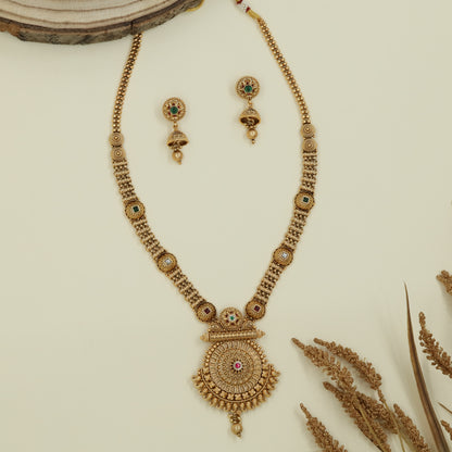 Embossed disc long haara with carved round connectors and layered circular pendant with drop
