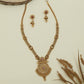 Embossed disc long haara with carved round connectors and layered circular pendant with drop