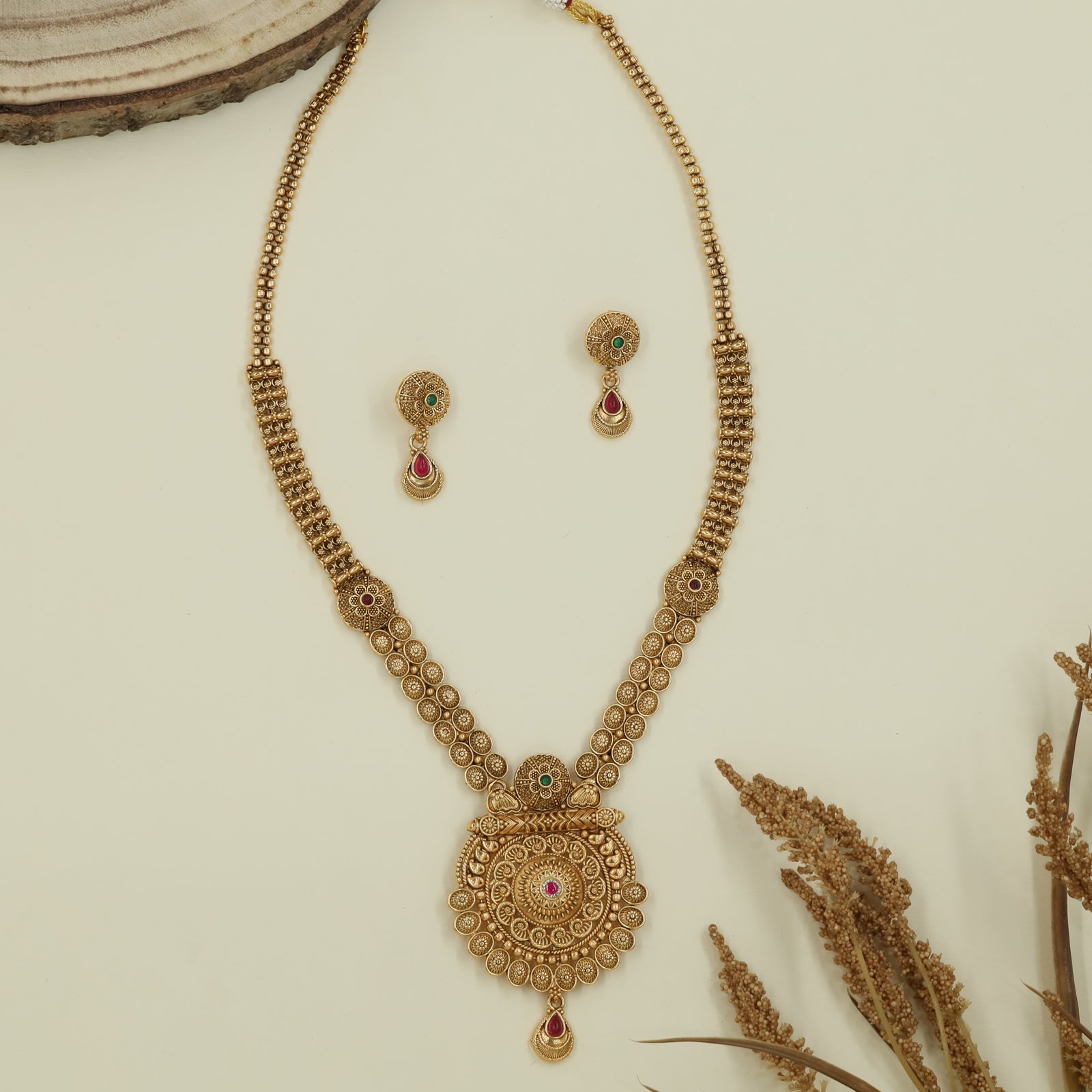 Floral disc antique long haara with patterned round panels and medallion pendant with hanging element