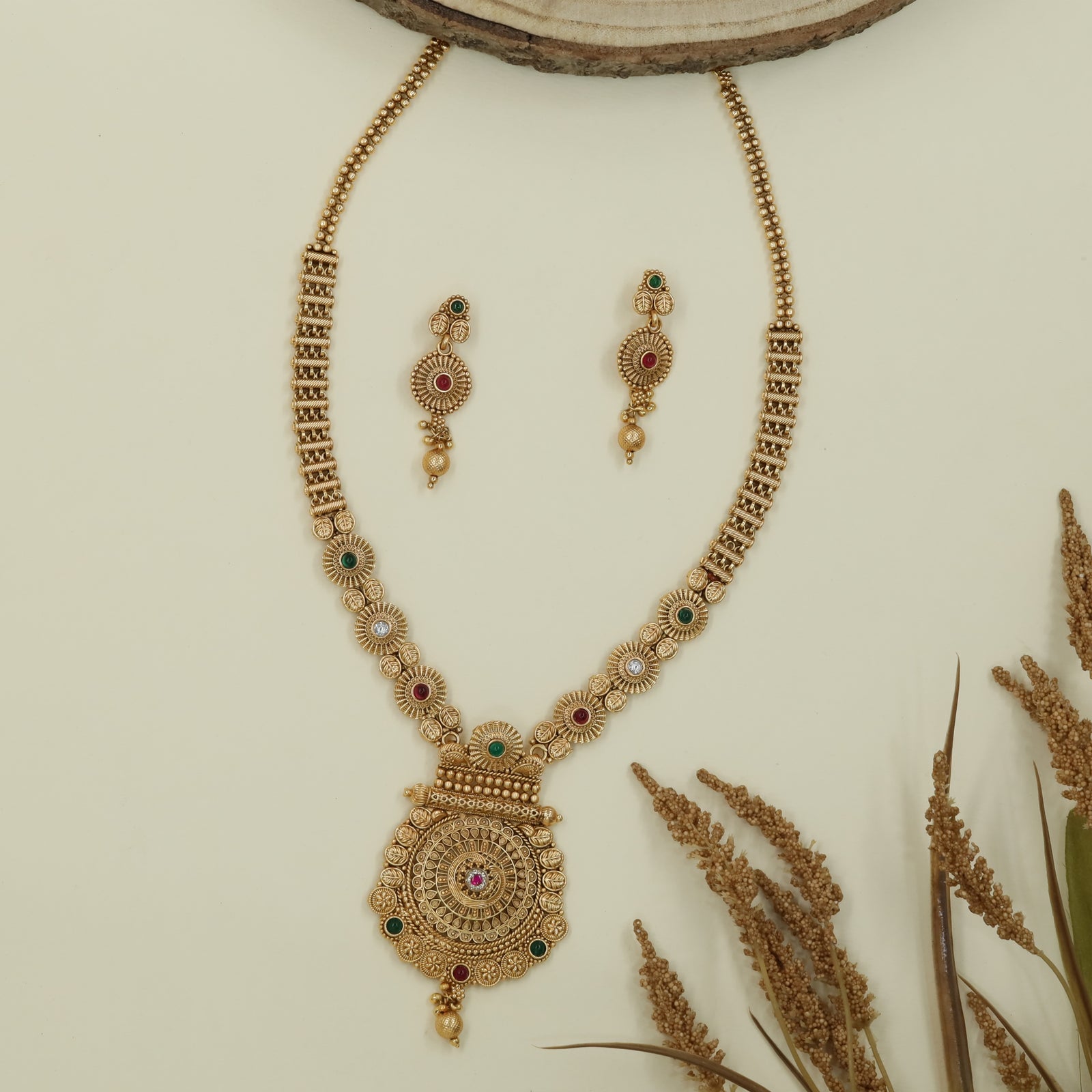 Floral disc antique long haara with patterned panels and layered medallion drop
