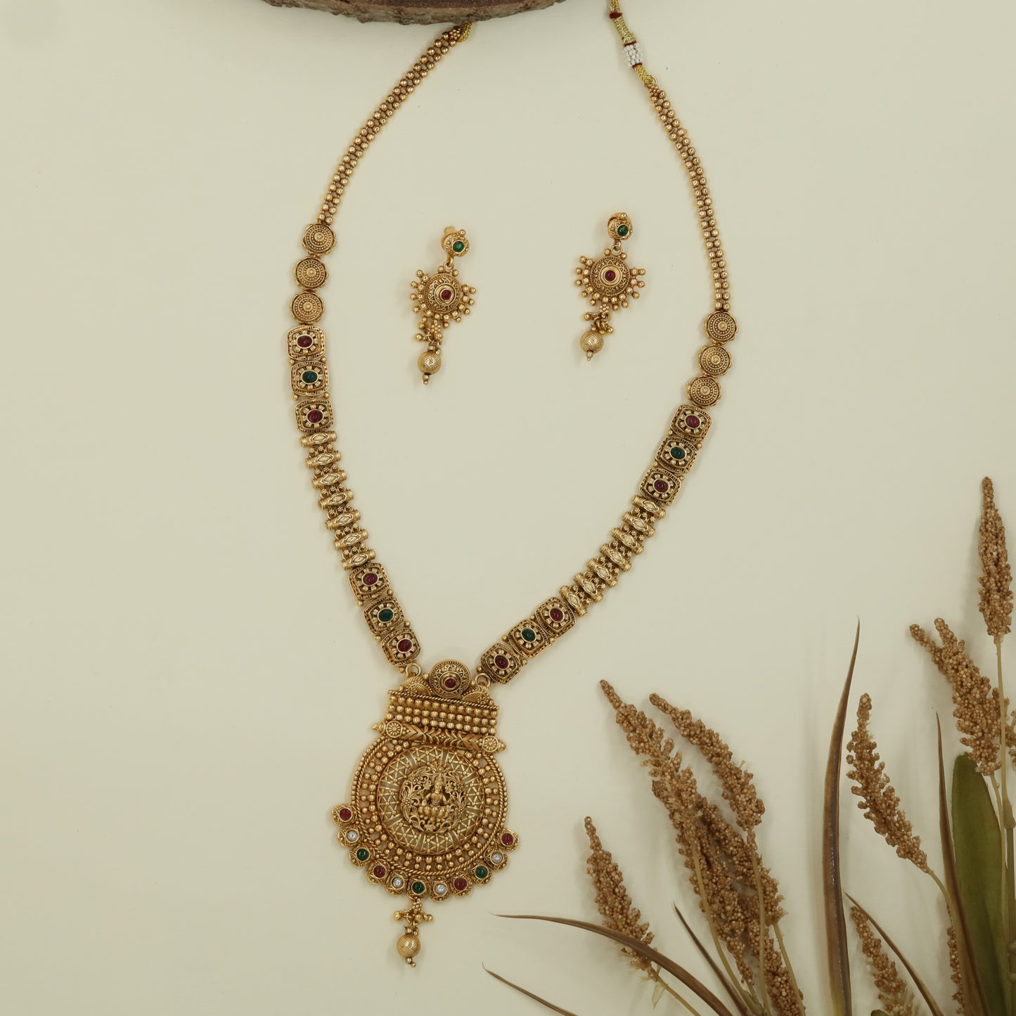 Embossed chain antique long haara with structured links and broad pendant with drop element