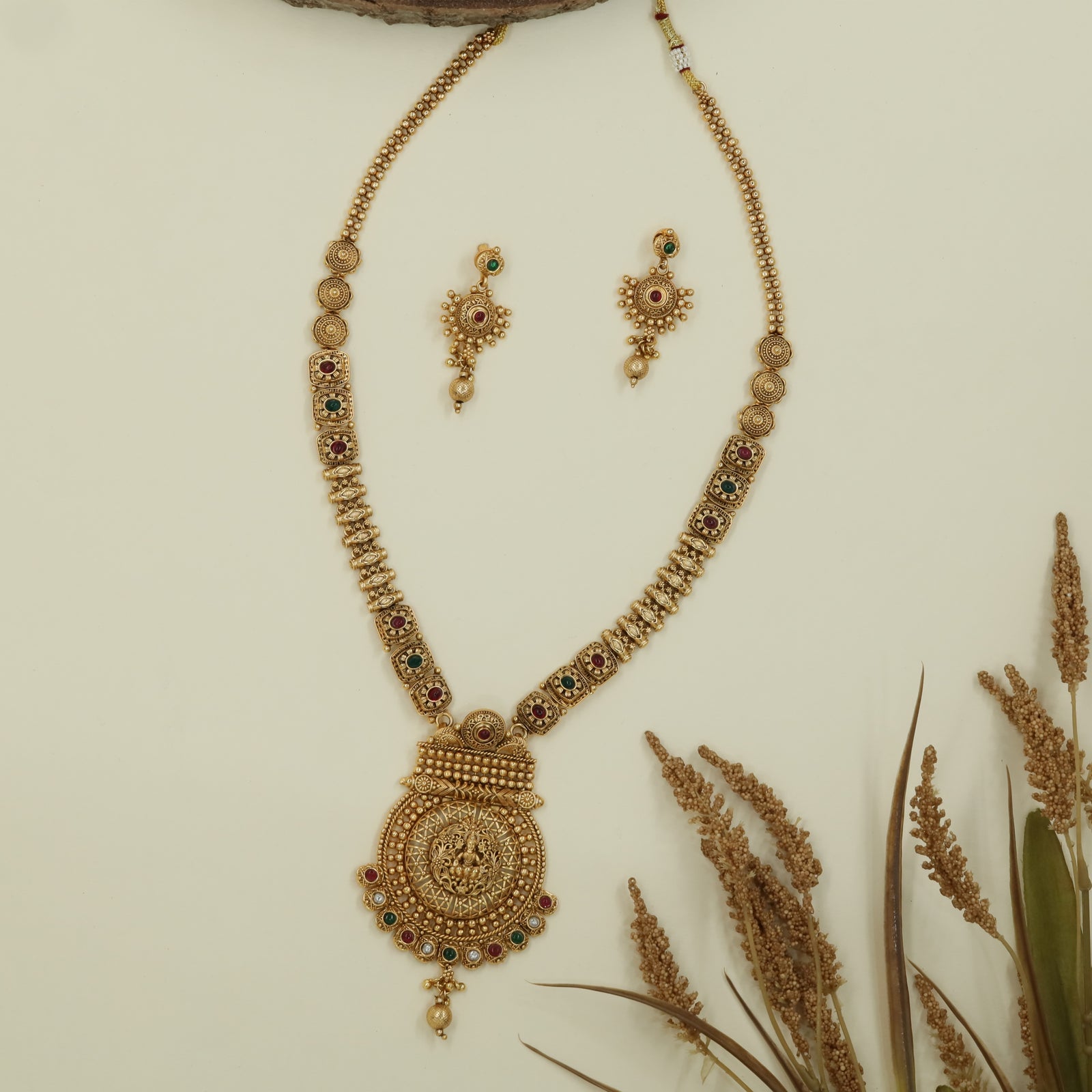Embossed chain antique long haara with structured links and broad pendant with drop element