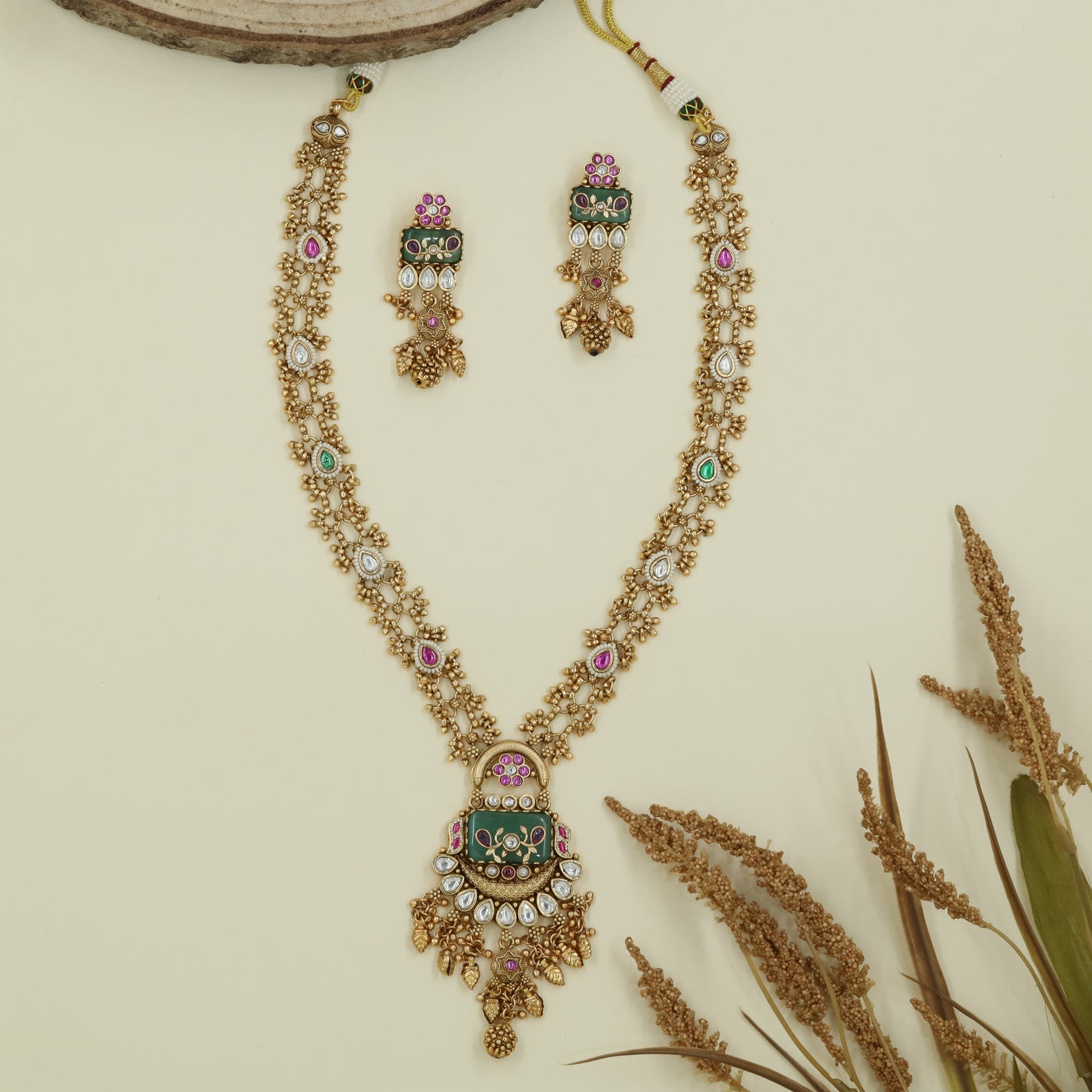 Dual strand kundan long haara with clustered bead chains and decorative enamel pendant with dangles