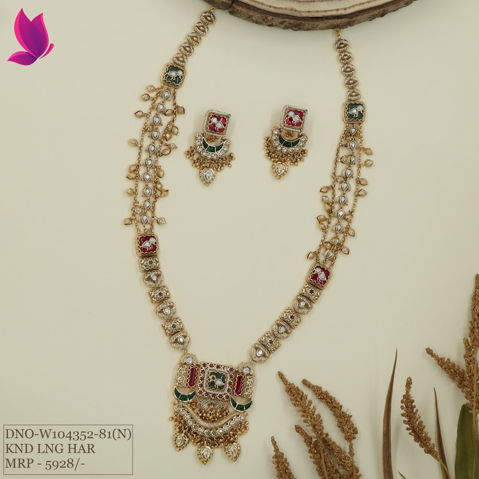 A kundan long haara featuring structured panel links with side chain drapes and a detailed fringe pendant paired with matching drop earrings.
