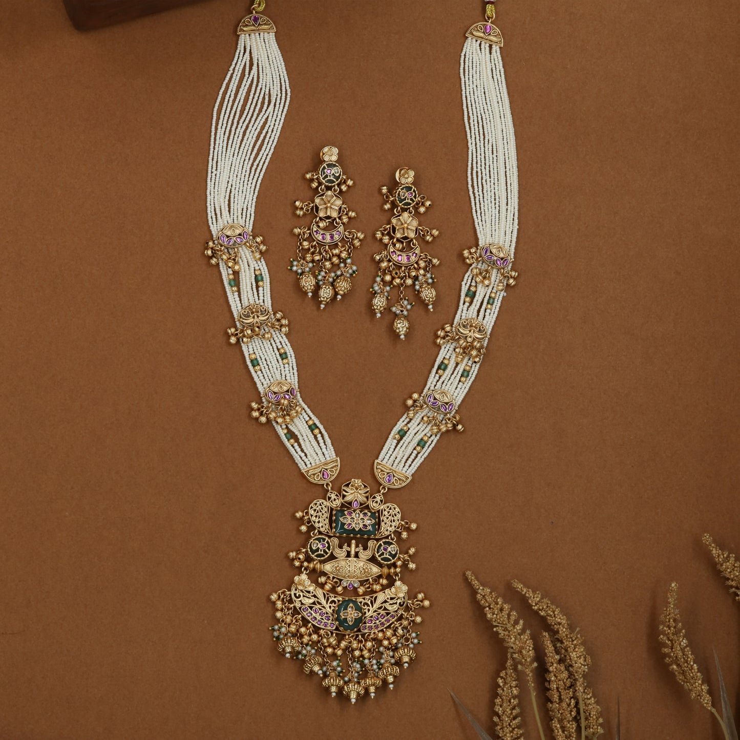 Arched pearl strand kundan long haara with side bead clusters and grand tiered pendant