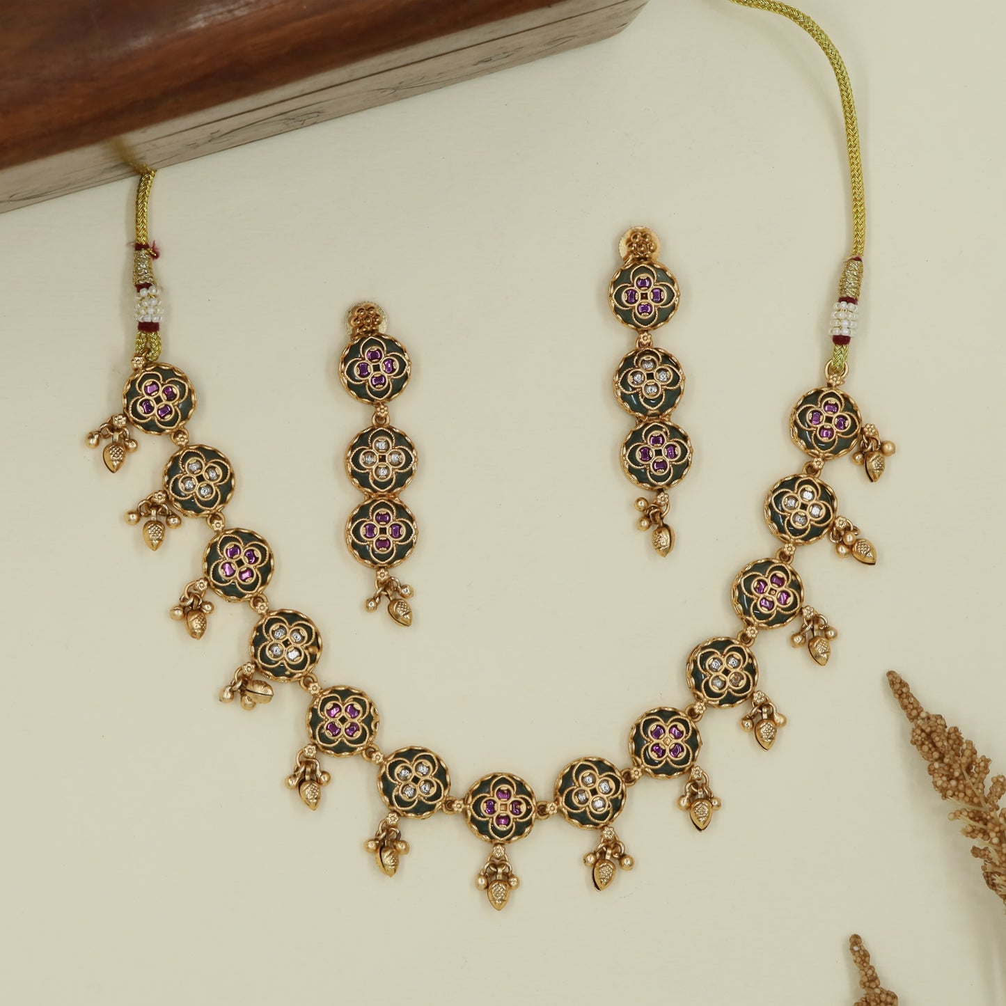 Floral round kundan necklace with repeated disc links and hanging drops