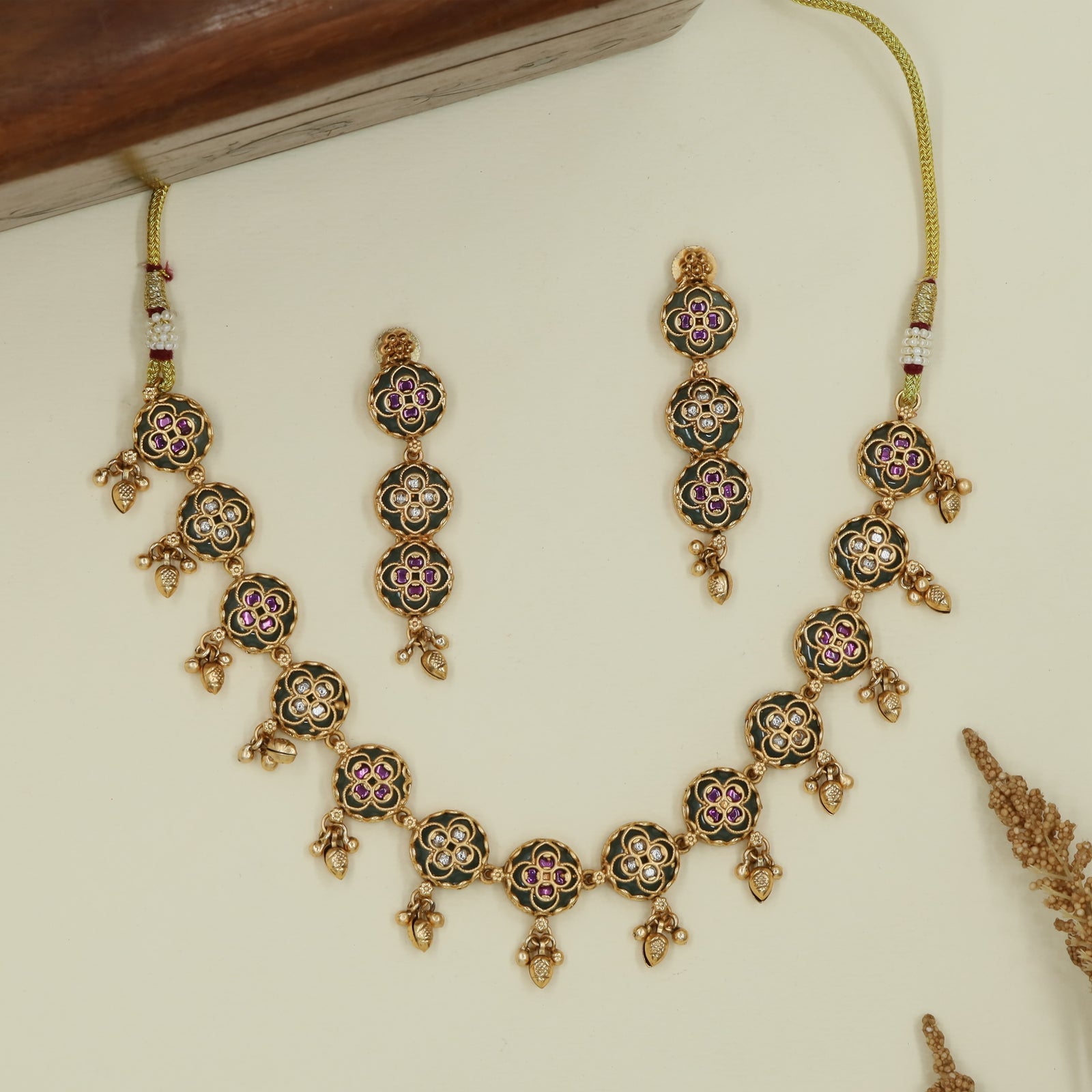 Floral round kundan necklace with repeated disc links and hanging drops