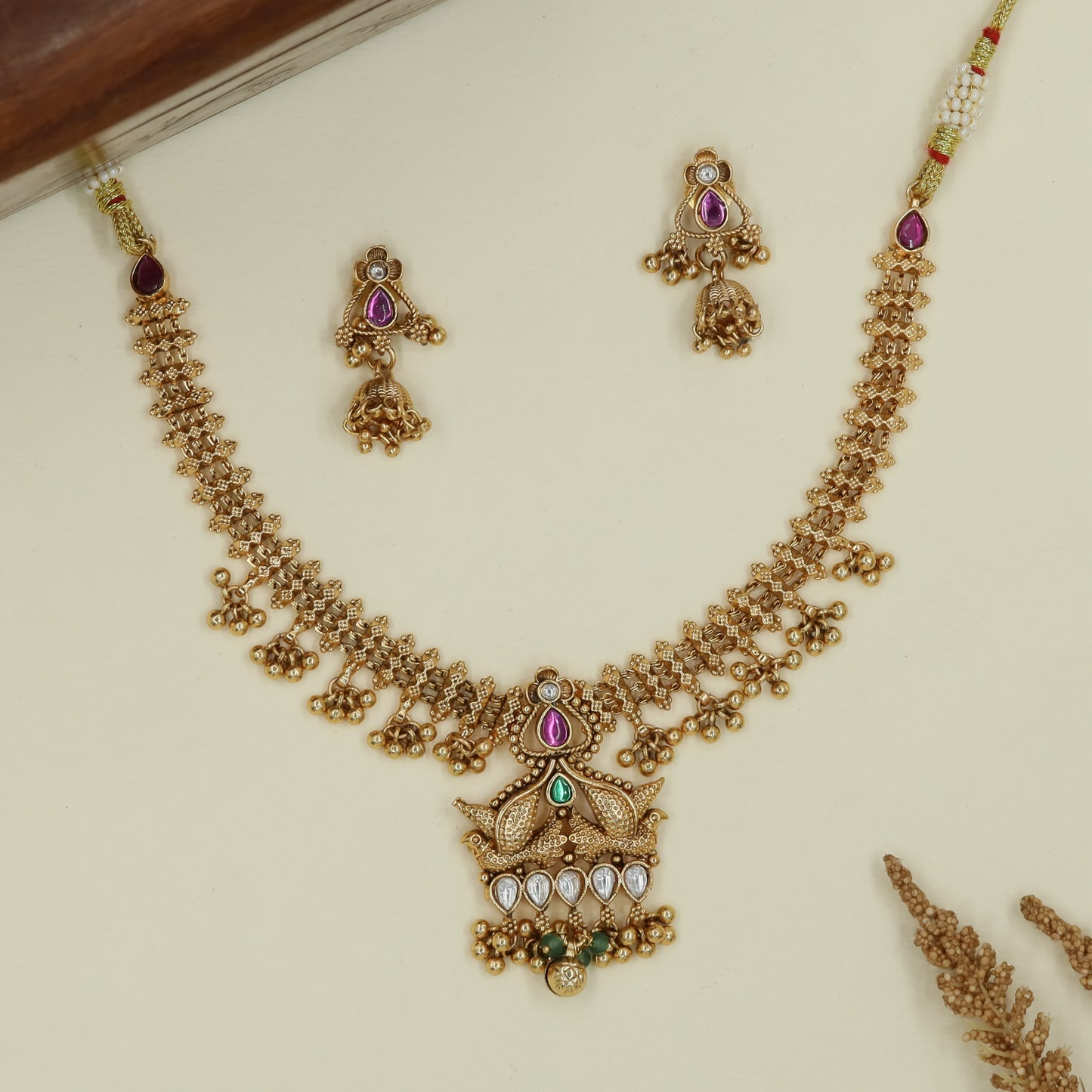 Crisscross link antique necklace with clustered drops and layered peacock base