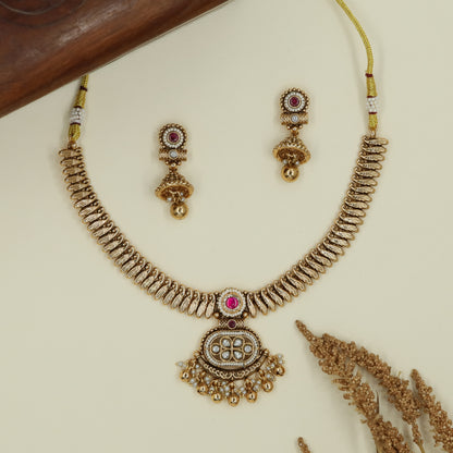 Spine pattern antique necklace with aligned curved links and hanging fringe