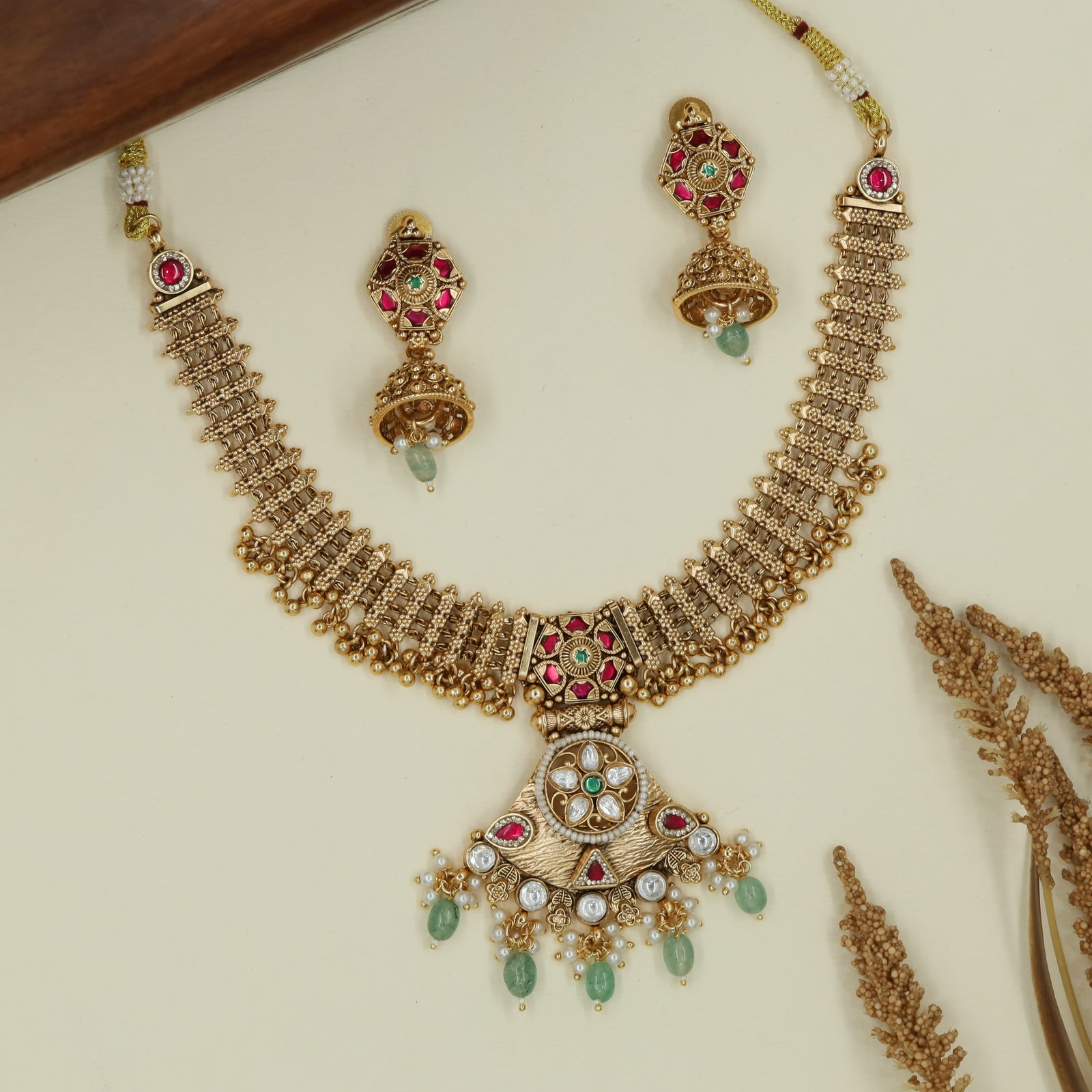 Grid strip kundan necklace with structured links and round pendant assembly