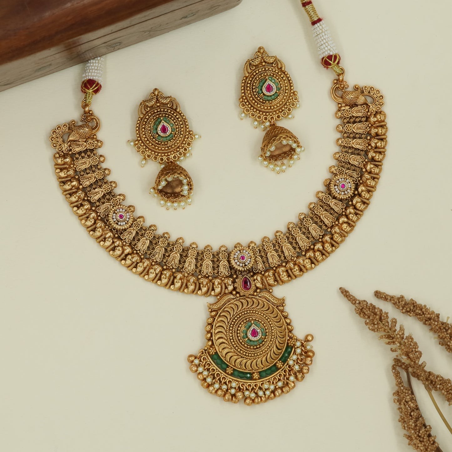 Curved temple panel kundan necklace with sculpted peacock side elements and large circular pendant