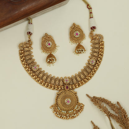 Curved temple panel kundan necklace with sculpted peacock side elements and large circular pendant