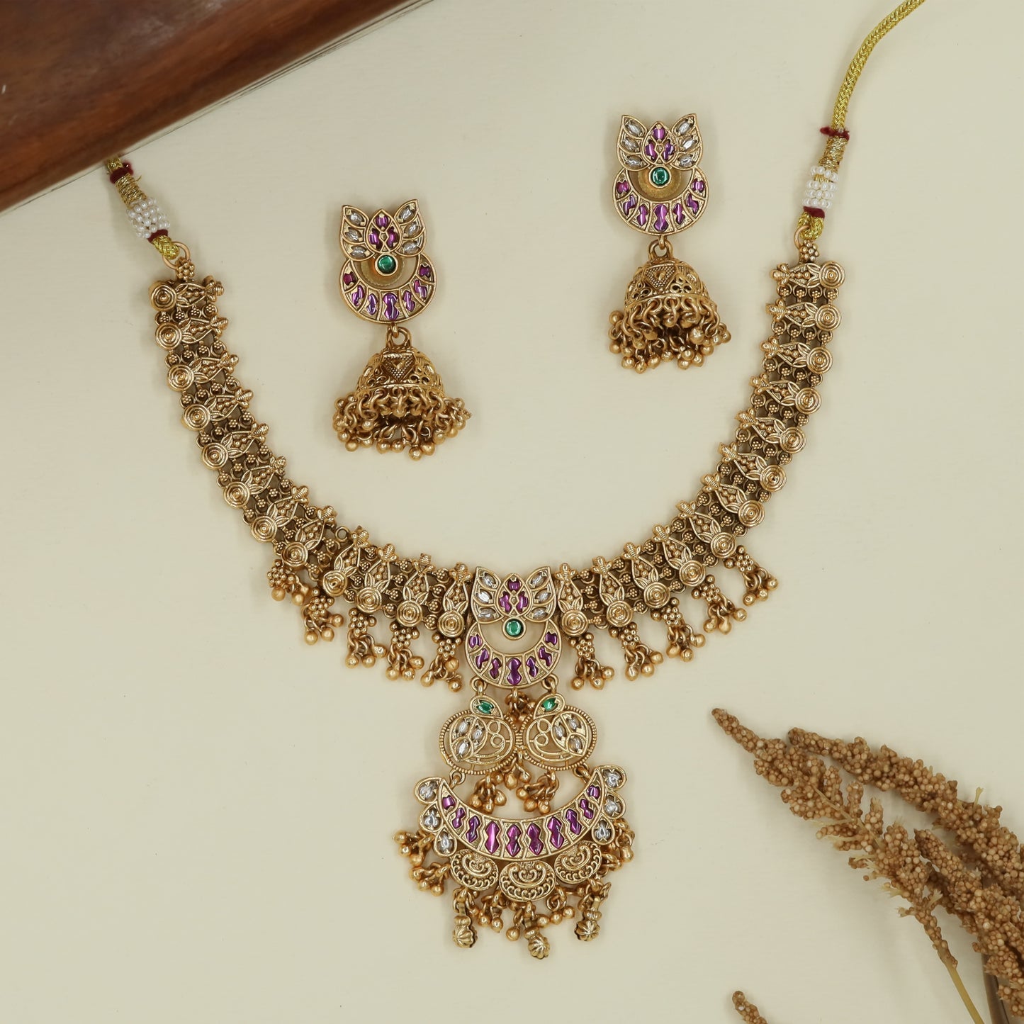 Braided link kundan necklace with spiral connector rows and tiered pendant with crescent arc panels