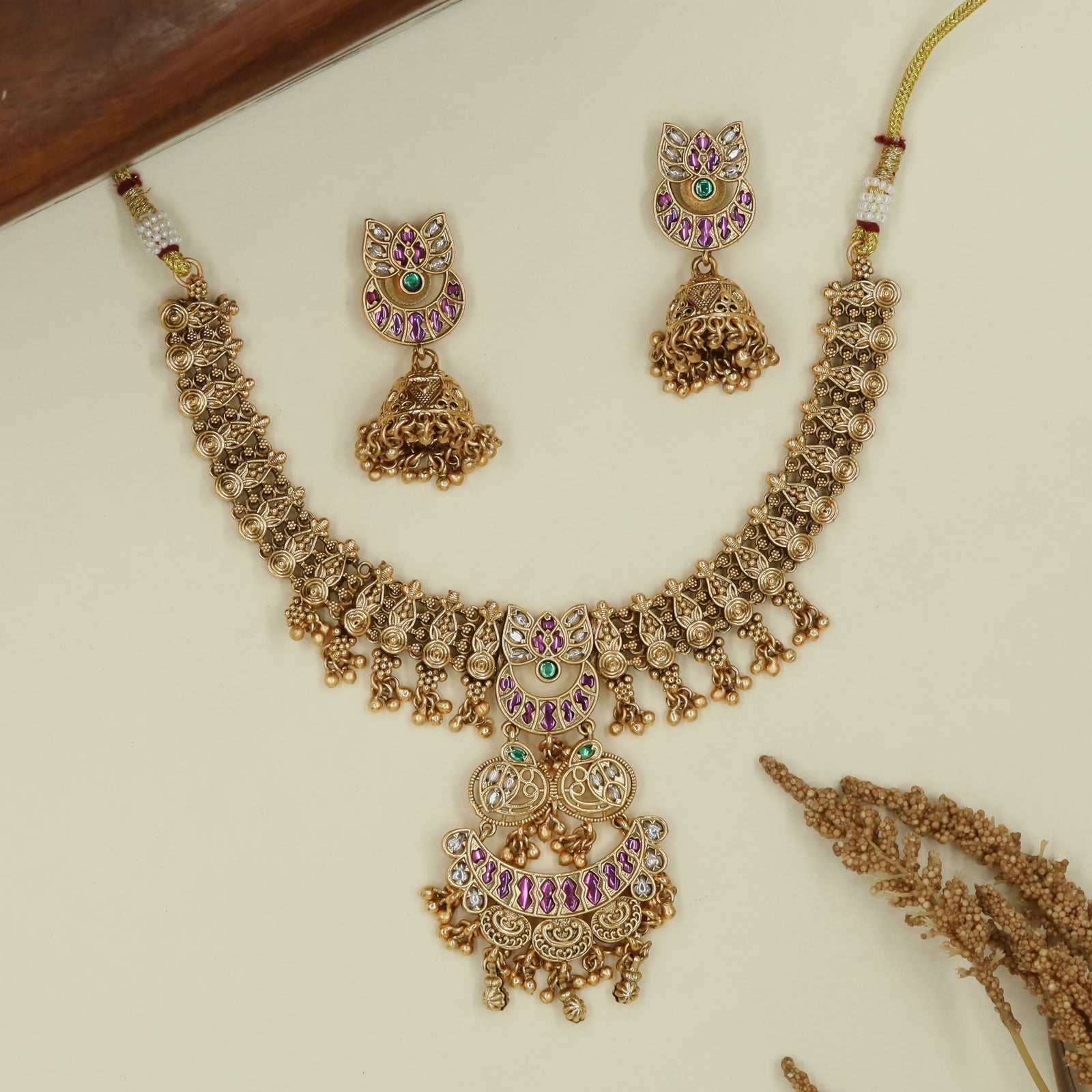 Braided link kundan necklace with spiral connector rows and tiered pendant with crescent arc panels