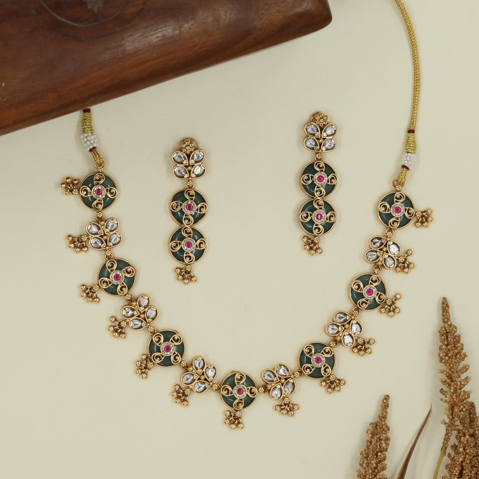 Decorative round unit kundan necklace with enamel panels and clustered hanging accents