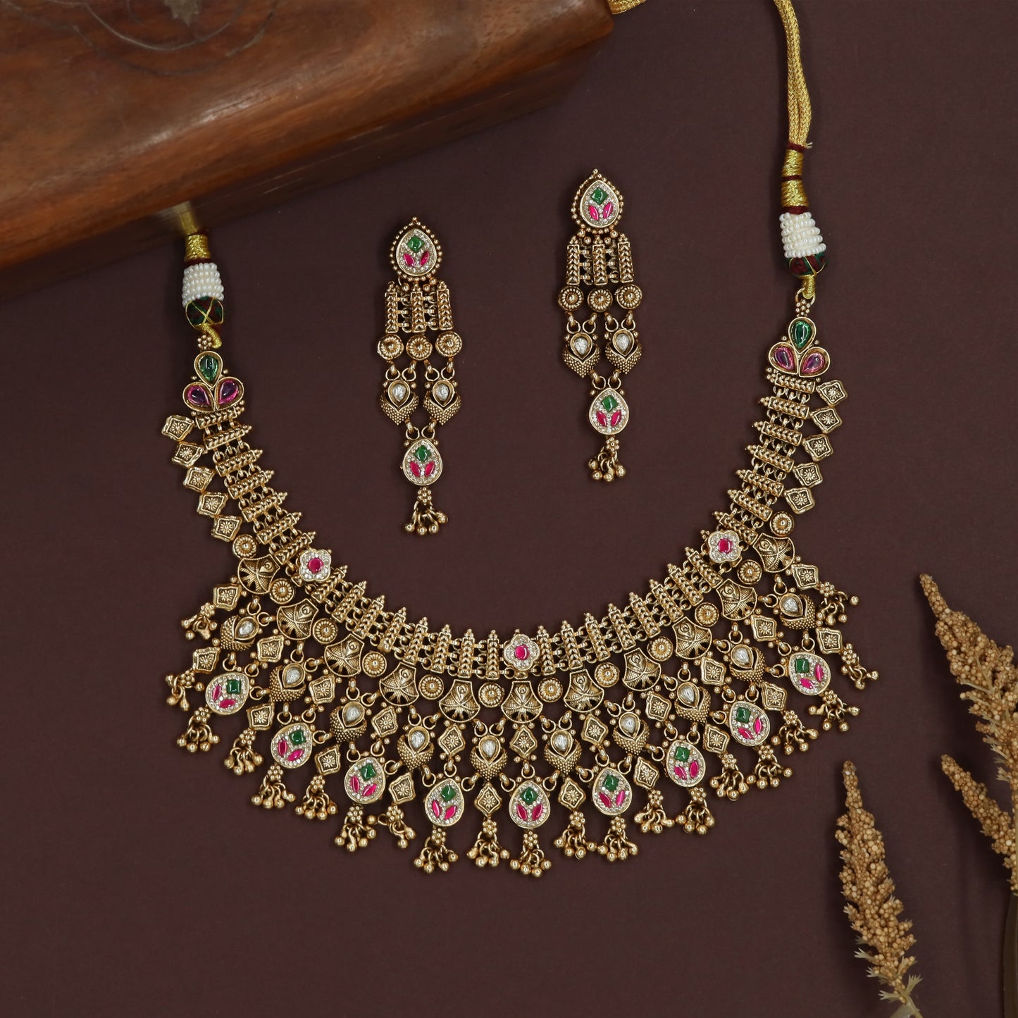 Alternating charm kundan necklace with heart drops and circular pendant clusters