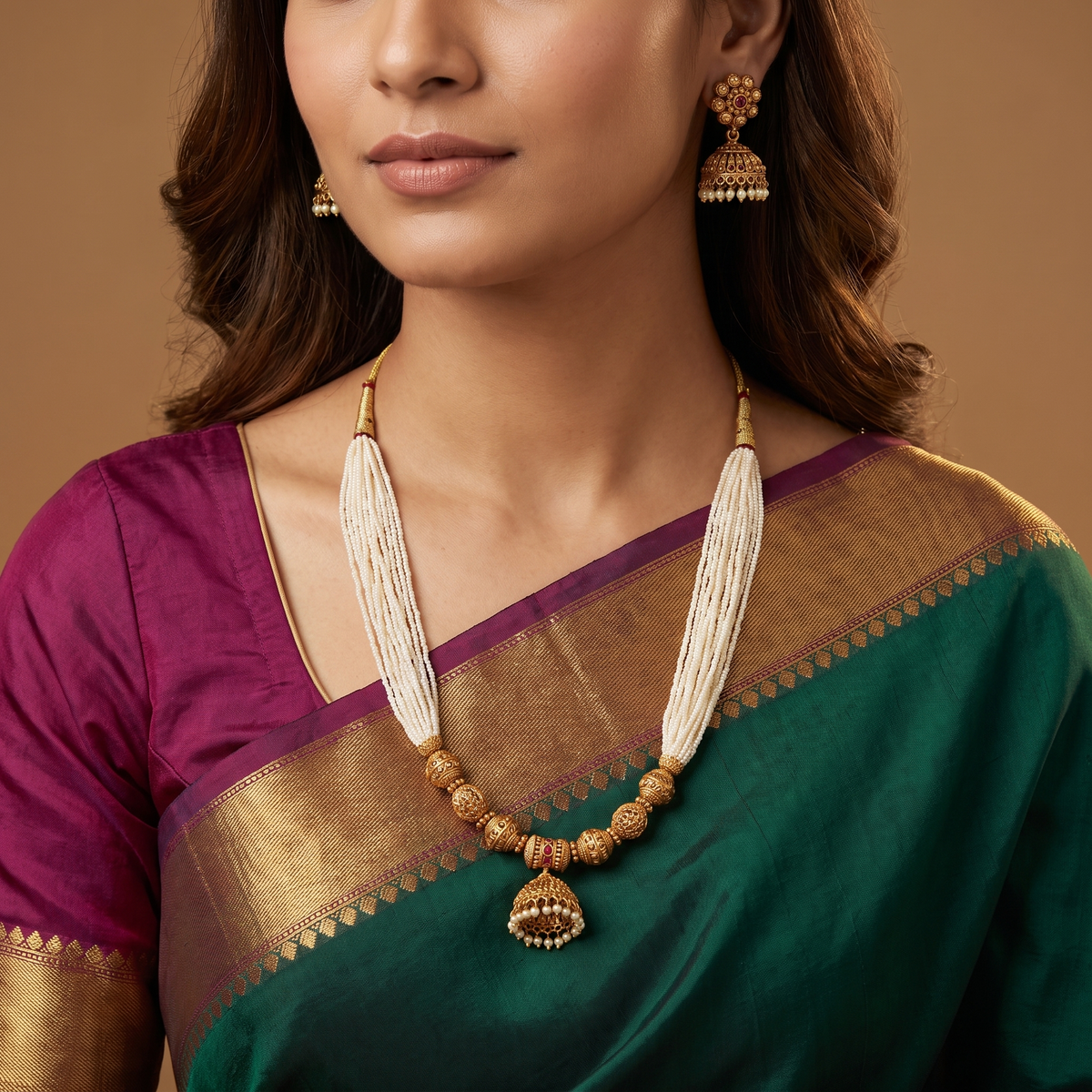 Multi strand pearl antique beads necklace with textured gold bead center section and dangling jhumka pendant