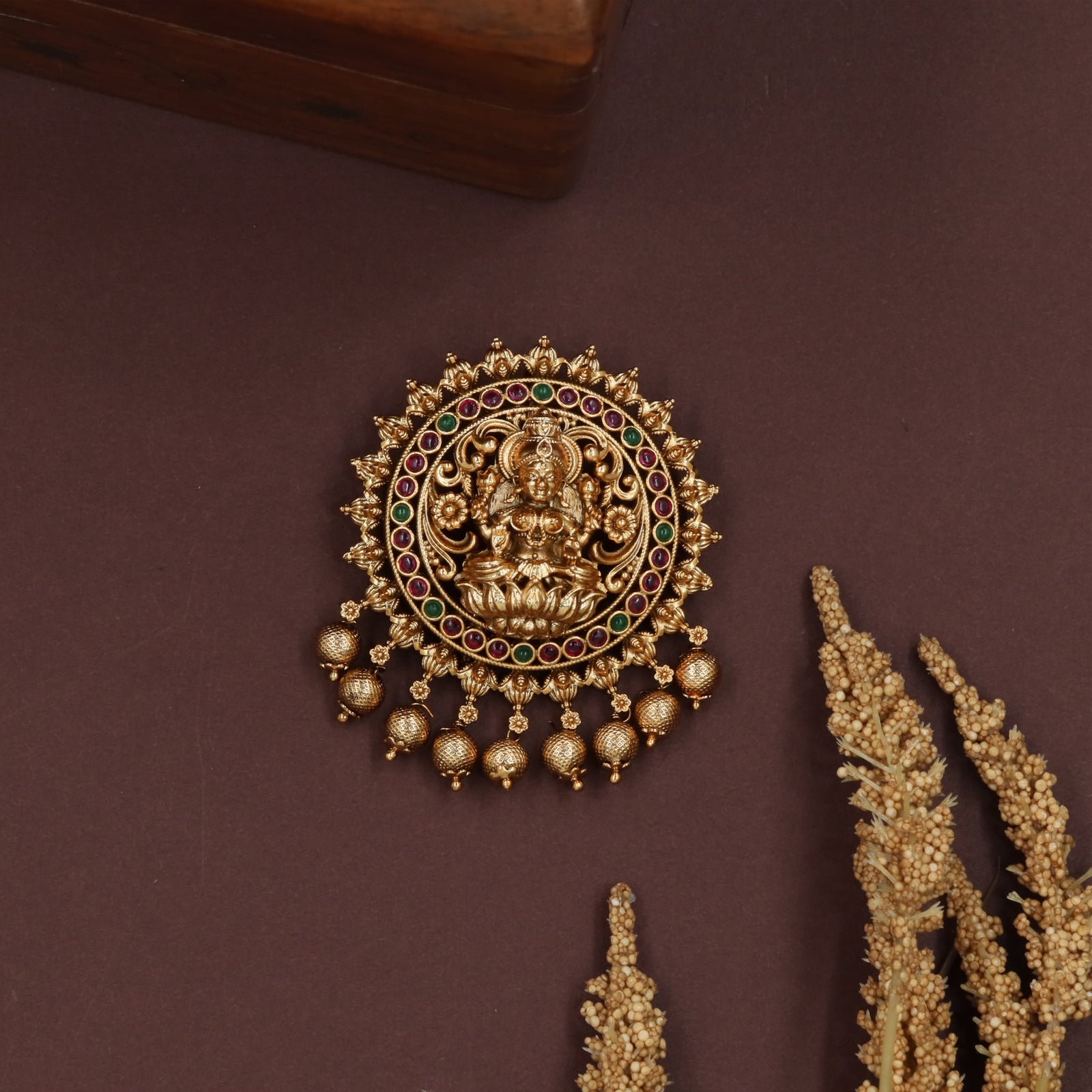 Lakshmi medallion jade bille with seated deity center and beaded fringe drops