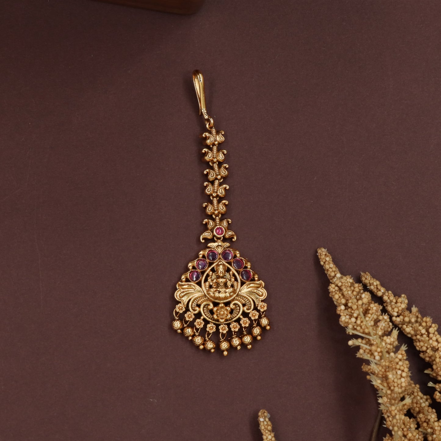 Decorative lakshmi tikka with scroll connectors and fringe bead edging