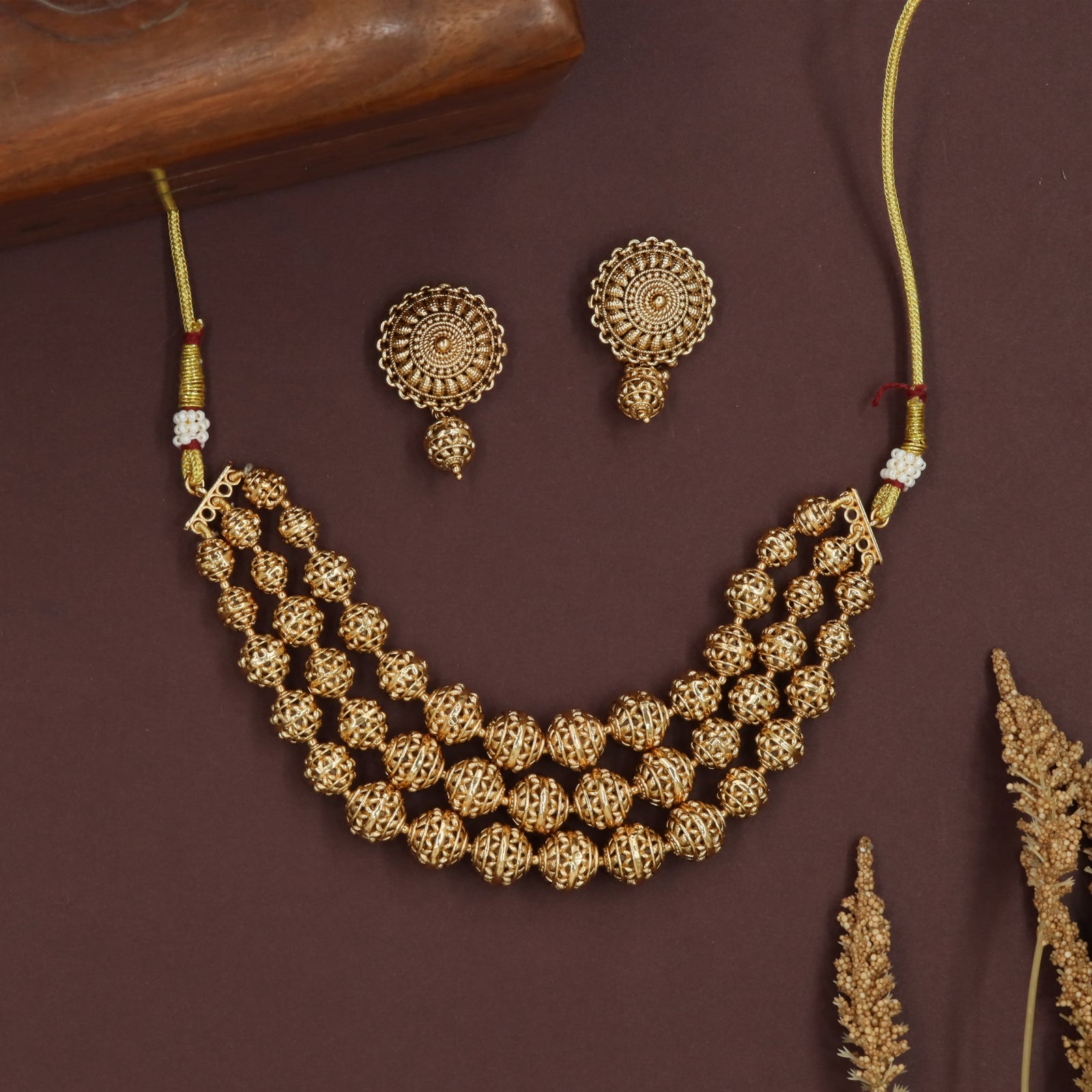 Hollow sphere antique necklace with openwork beads and triple strand flow
