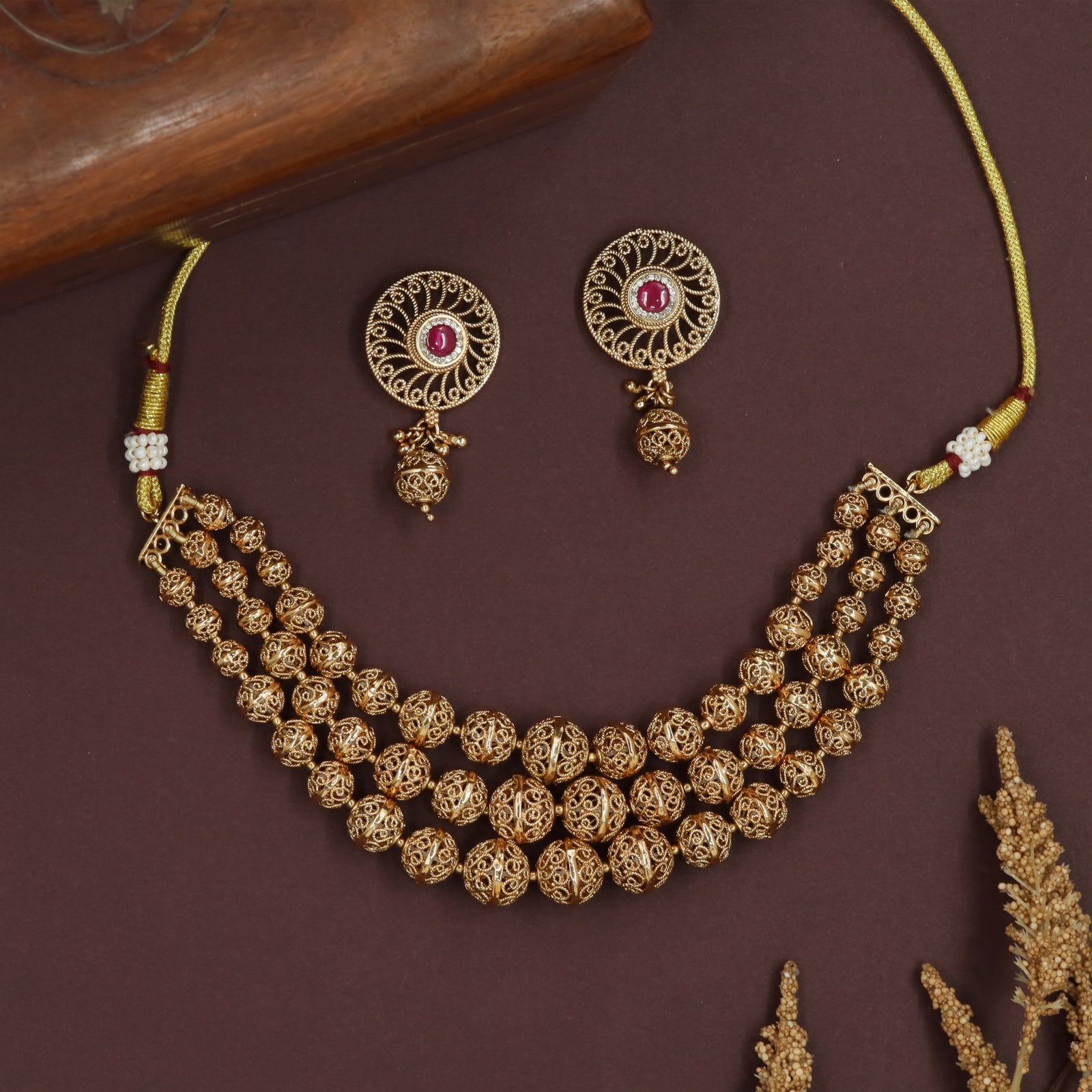 Ornate sphere antique necklace with openwork beads and tiered strand arrangement