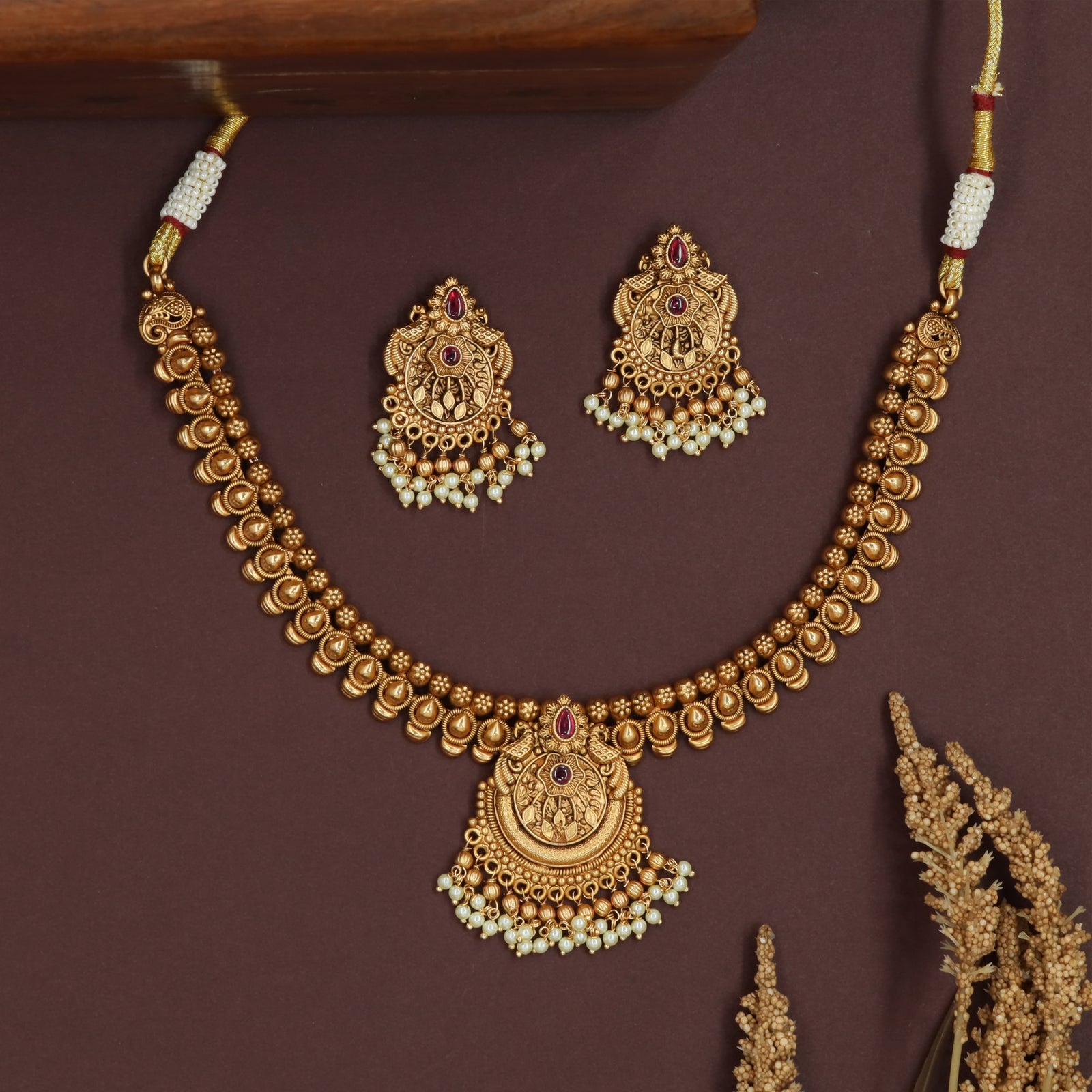 Teardrop row antique necklace with rounded bead line and central medallion pendant