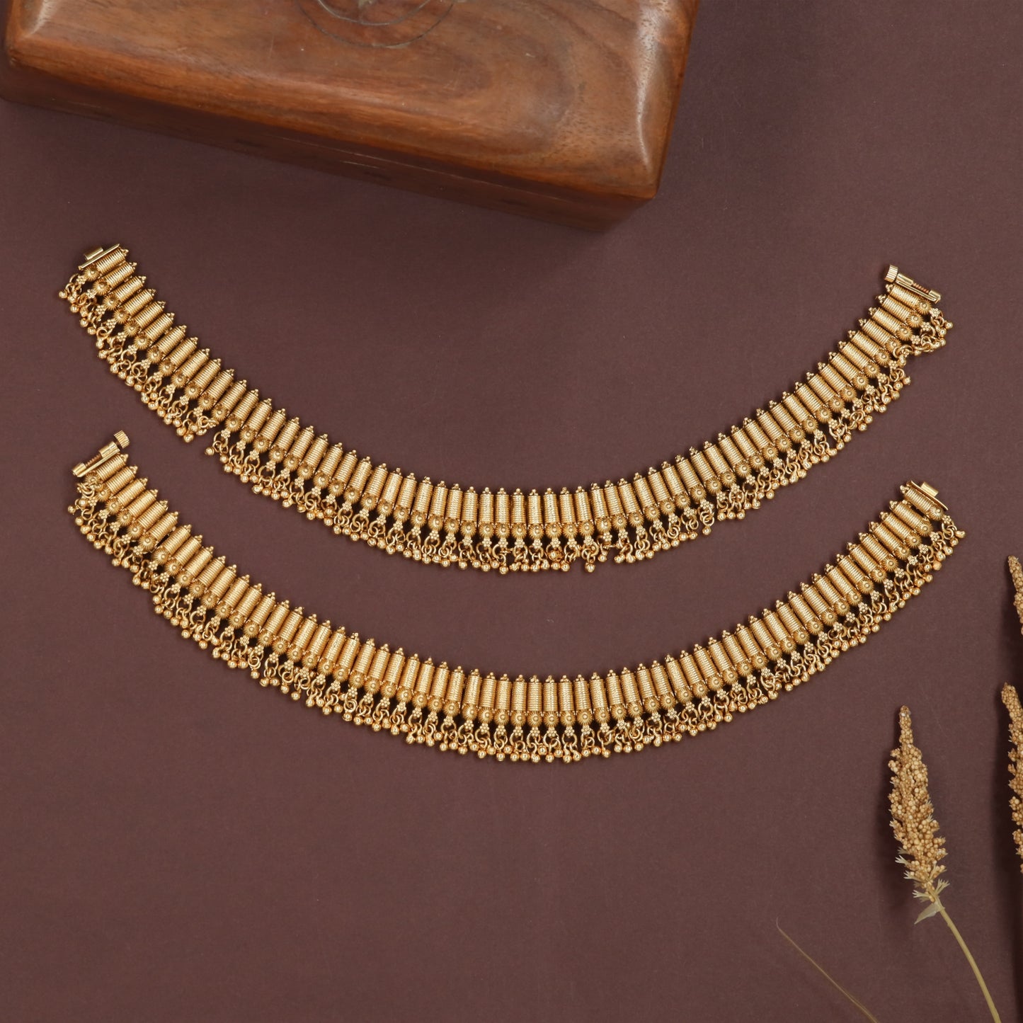 Vertical Design payal with tightly packed cylindrical segments and bead fringe border