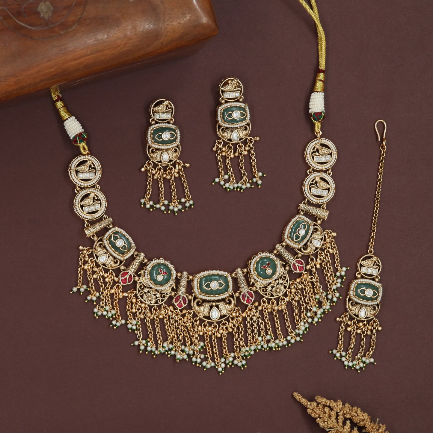 Decorative oval kundan necklace with linked panels and layered fringe drops