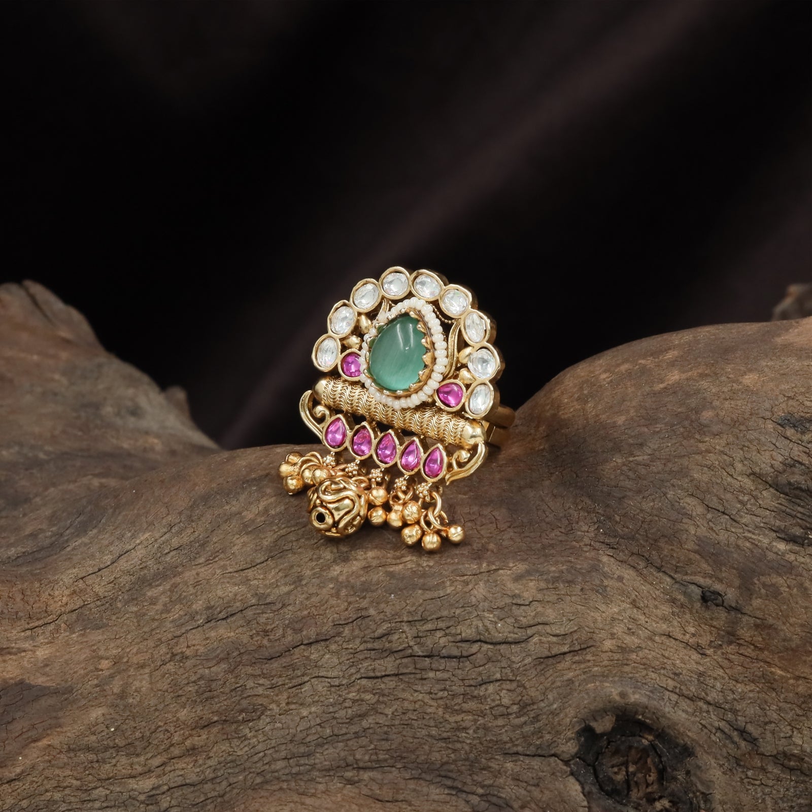 Beaded frame kundan finger ring with raised oval top and tassel cluster base