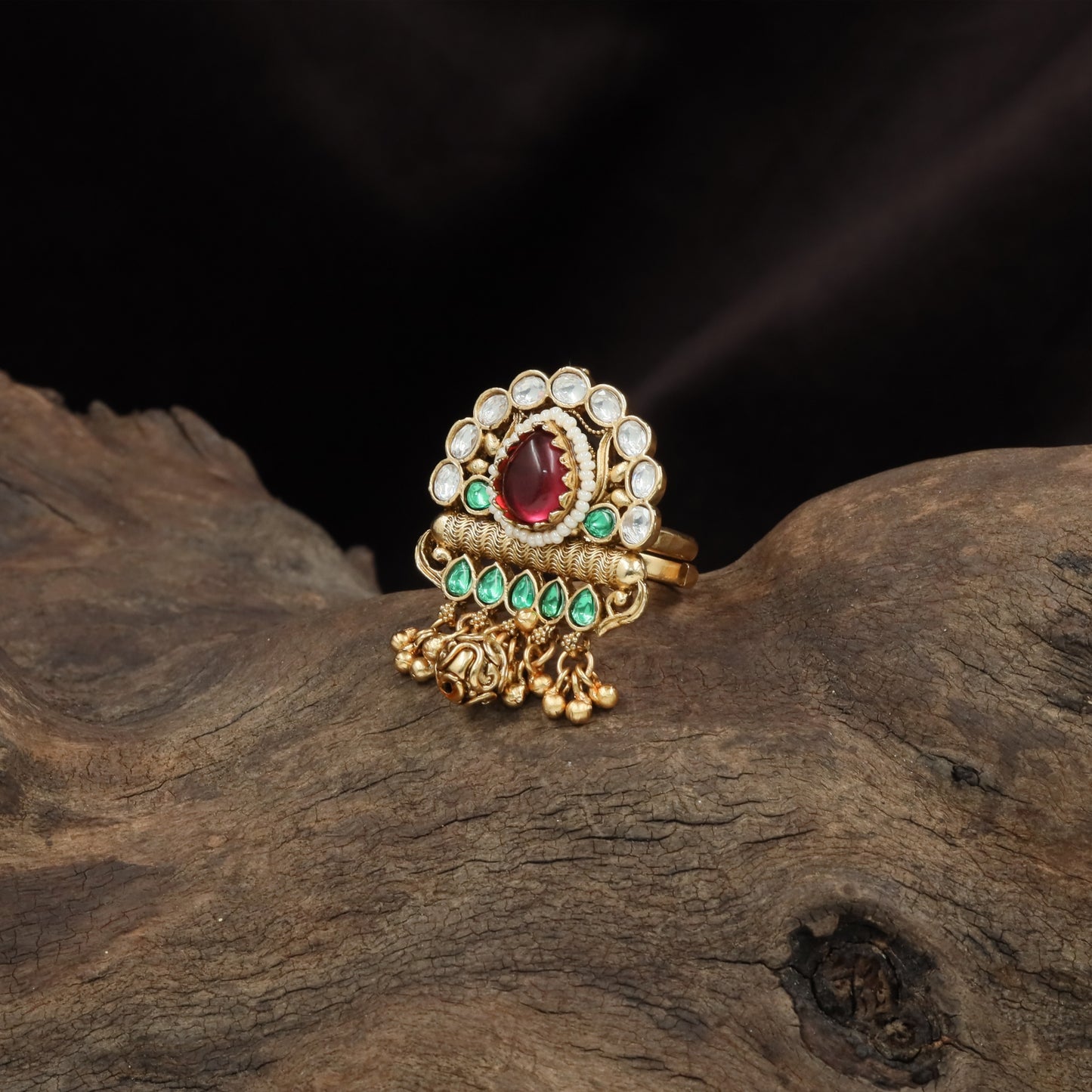 Decorative oval kundan finger ring with raised center and dangling bead accents