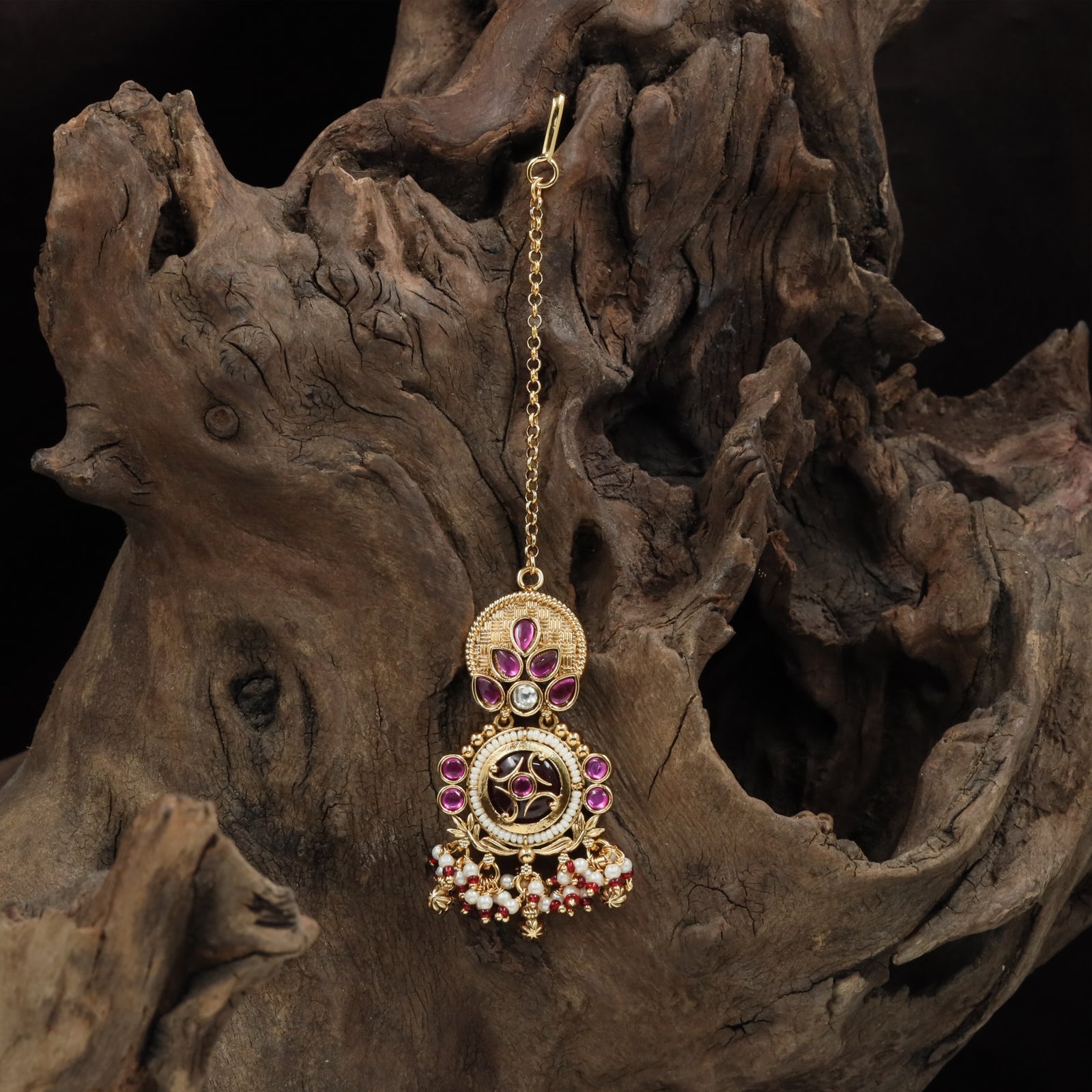 Circular top kundan tikka with leaf cluster connectors and framed drop medallion
