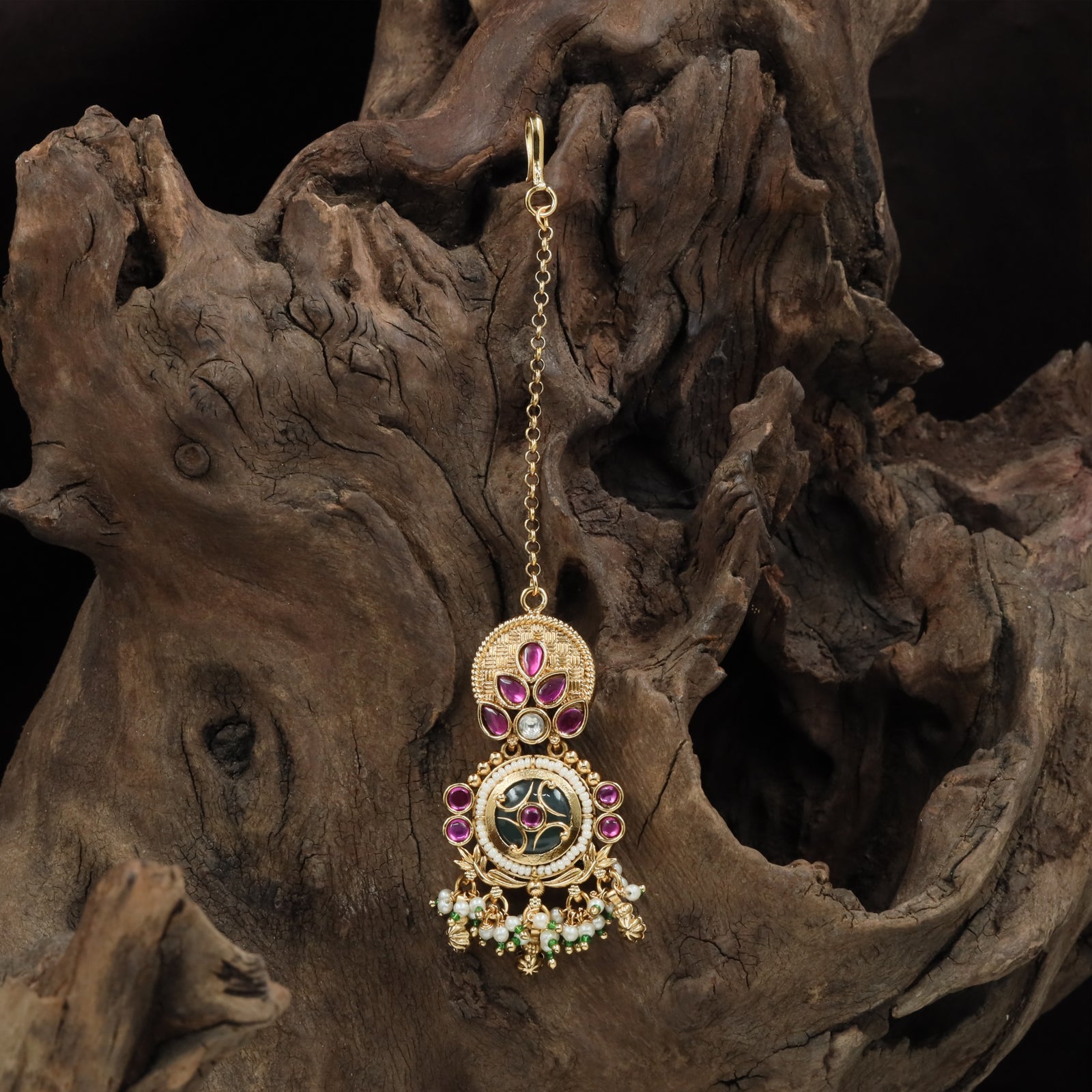 Circular top kundan tikka with leaf cluster connectors and framed drop medallion