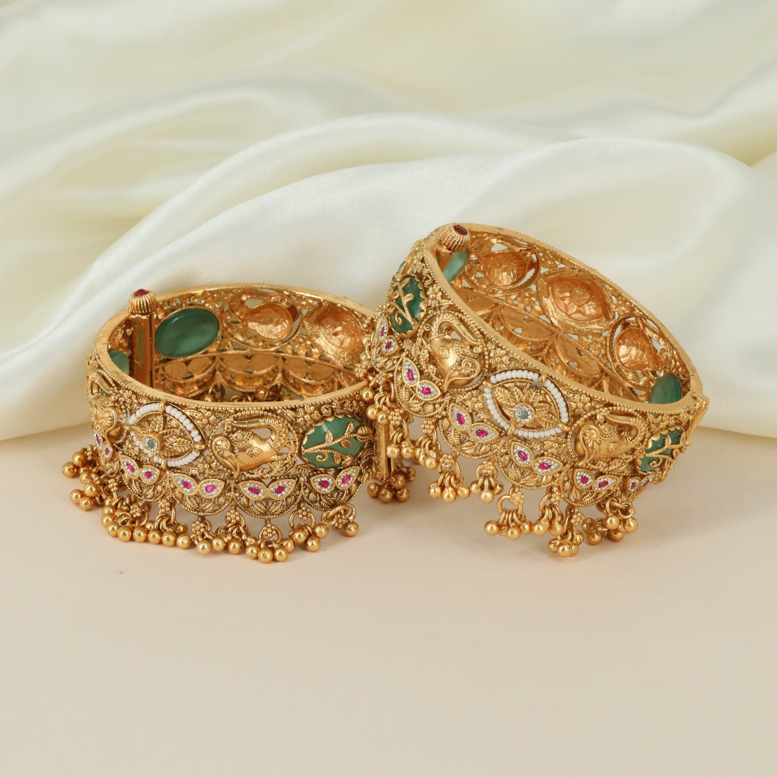 Bridal peacock motif kundan bangles with dangling golden clusters