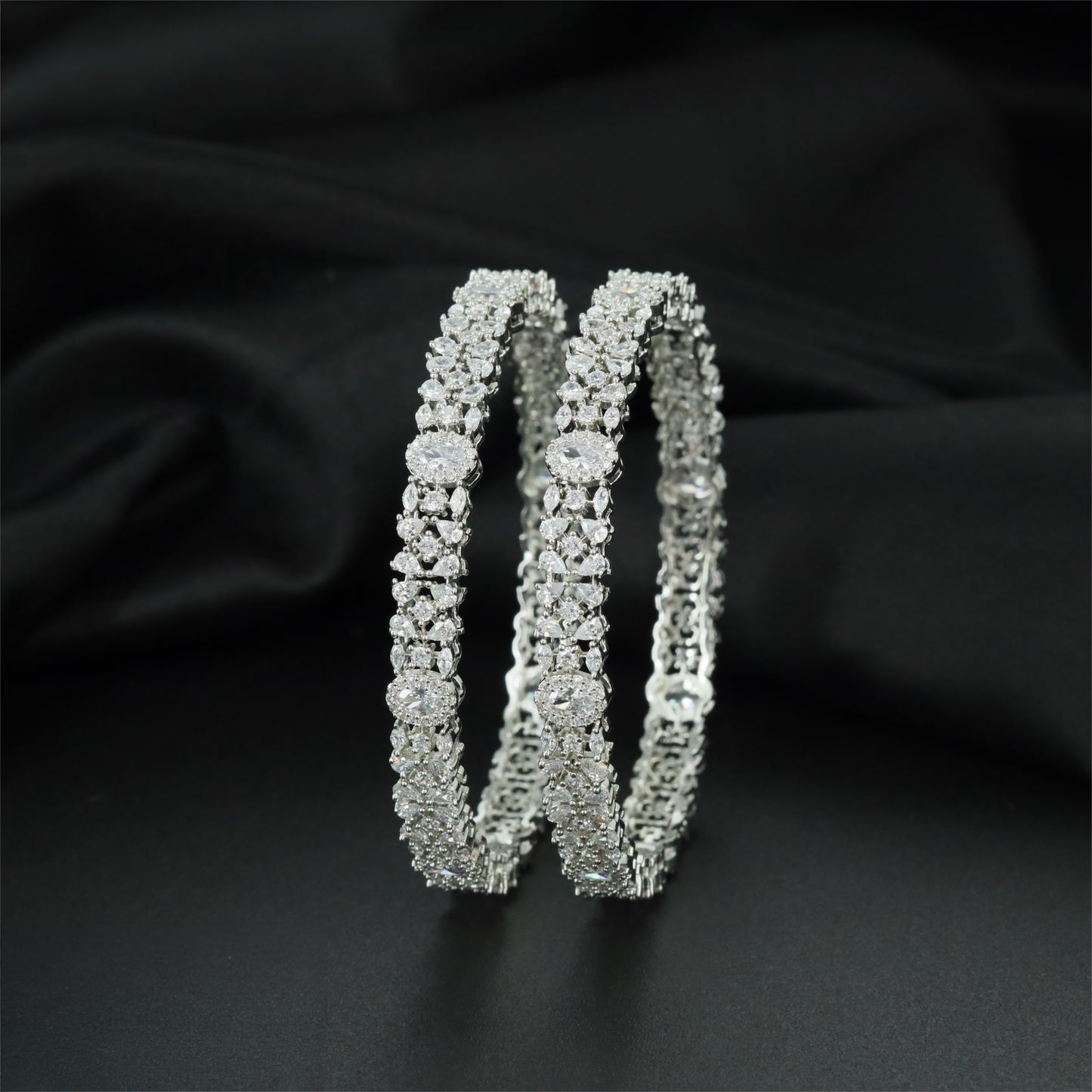 Refined Rhodium Bangles with Symmetrical Round Centre Elements
