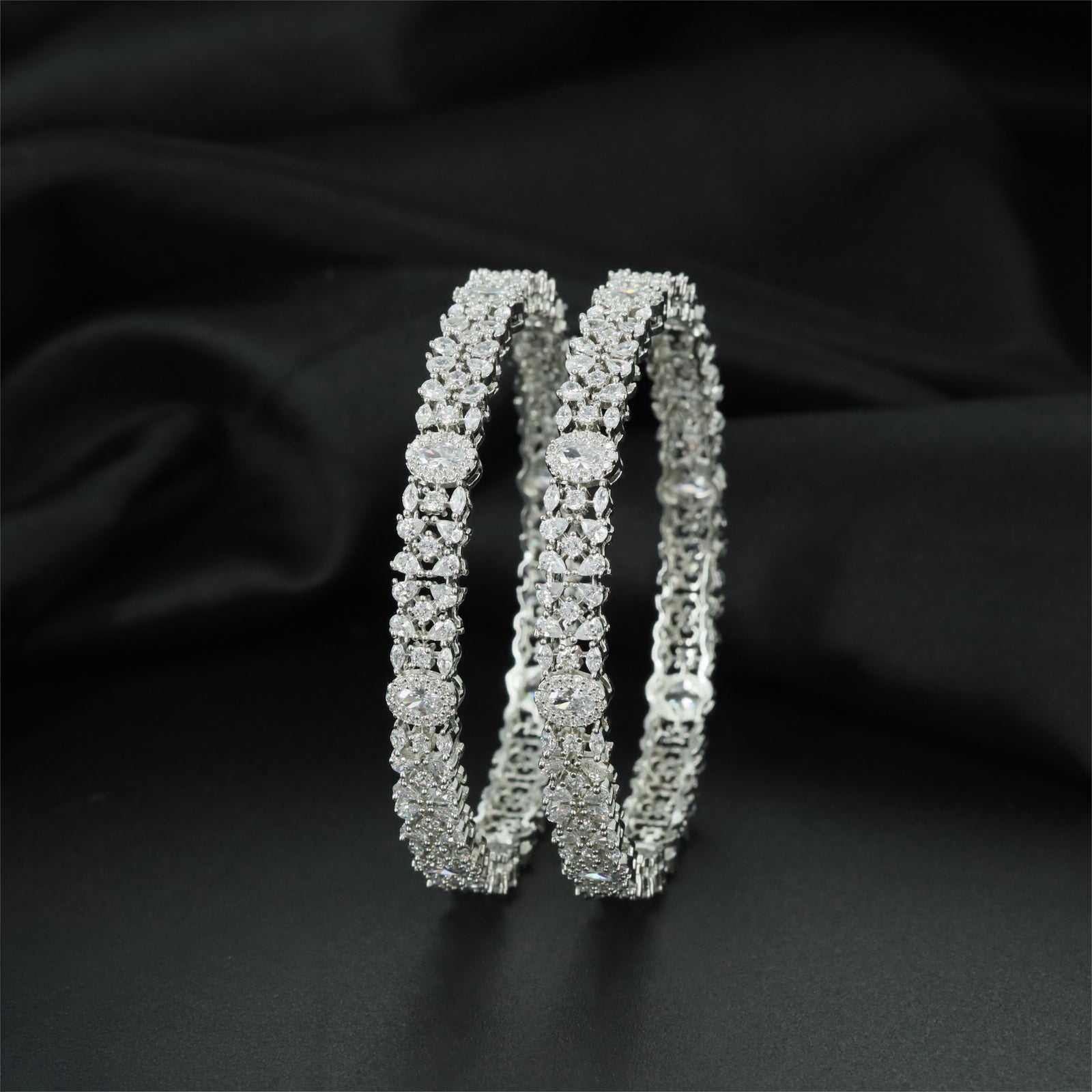 Refined Rhodium Bangles with Symmetrical Round Centre Elements