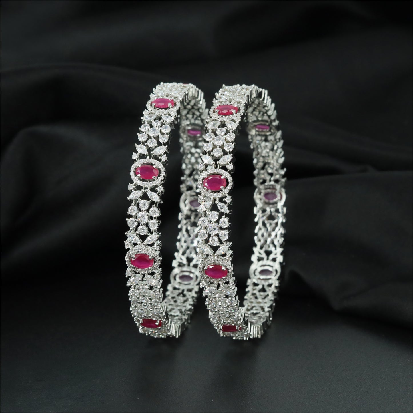 Elaborate Rhodium Bangles Showcasing Symmetrical Flower Clusters