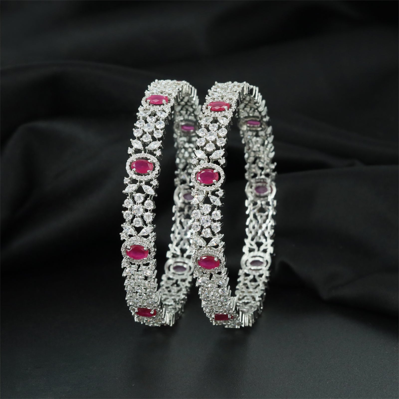 Elaborate Rhodium Bangles Showcasing Symmetrical Flower Clusters