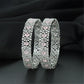 Rhodium bangles featuring framed oval elements and clustered stonework