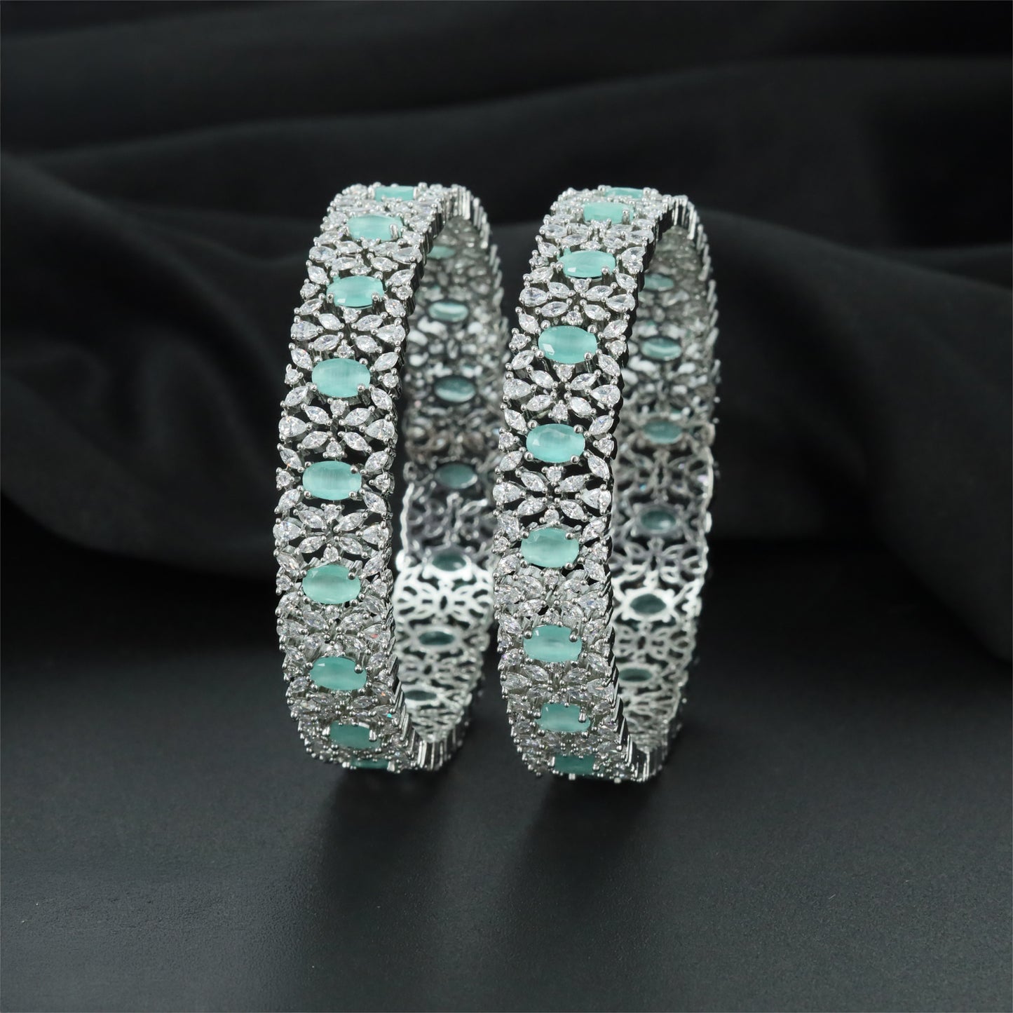 Refined Rhodium Bangles with Alternating Oval and Floral Forms