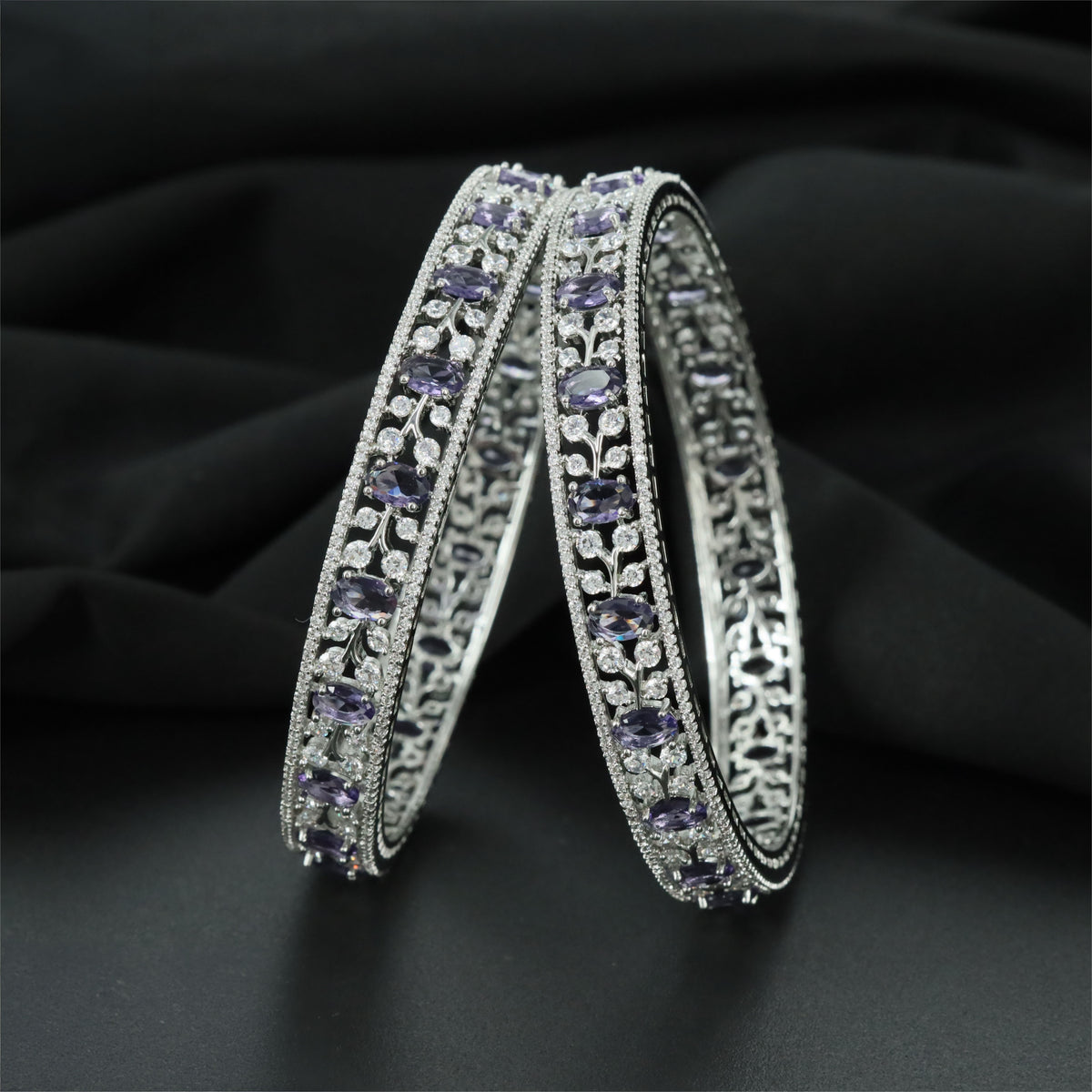 Elegant Rhodium bangles featuring a repeating ornamental pattern