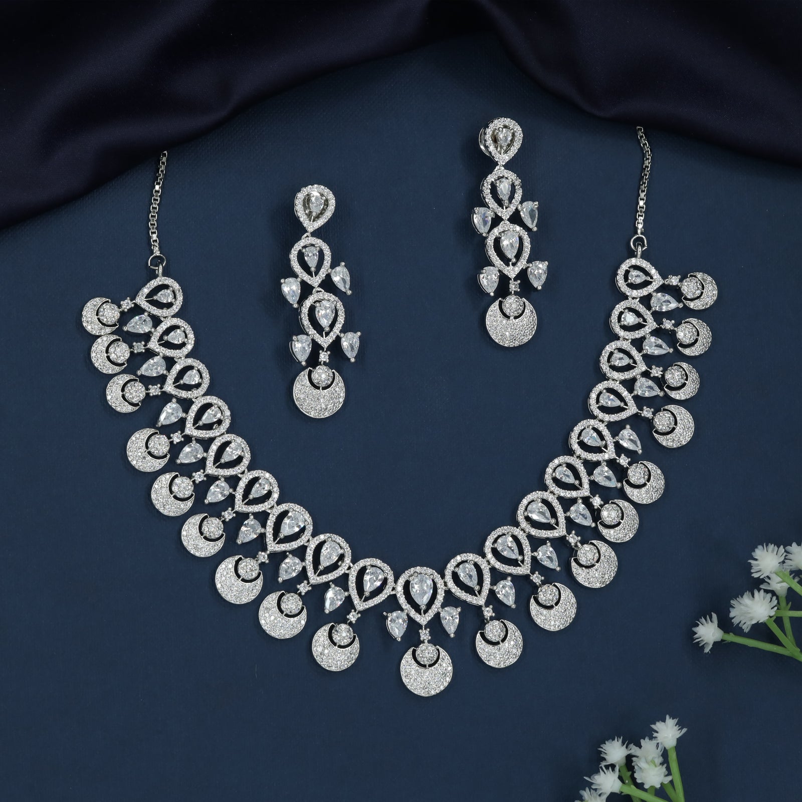 Dangling Disc Rhodium Necklace with Teardrop Border Styling