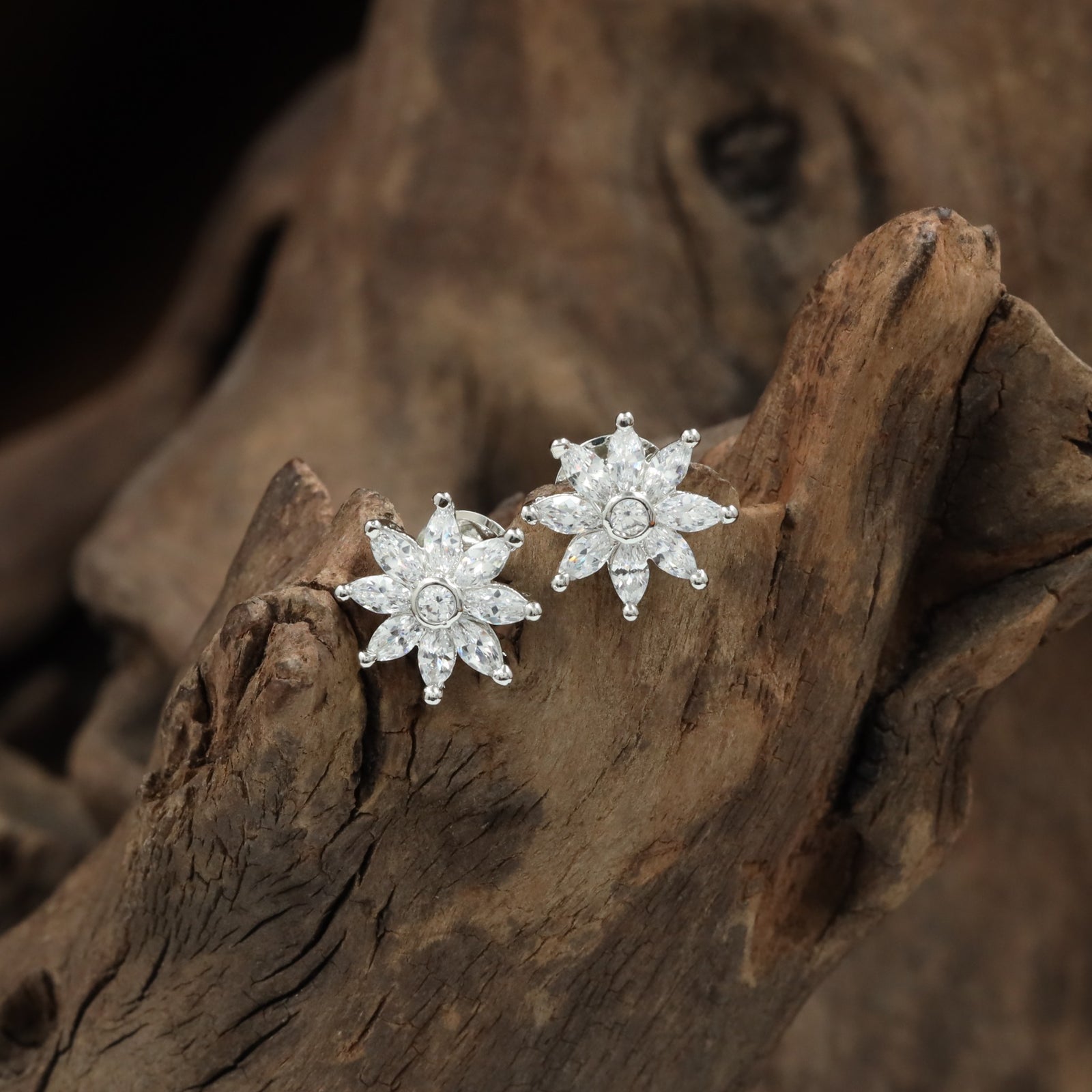 Flared flower rhodium stud with clustered crystal layout