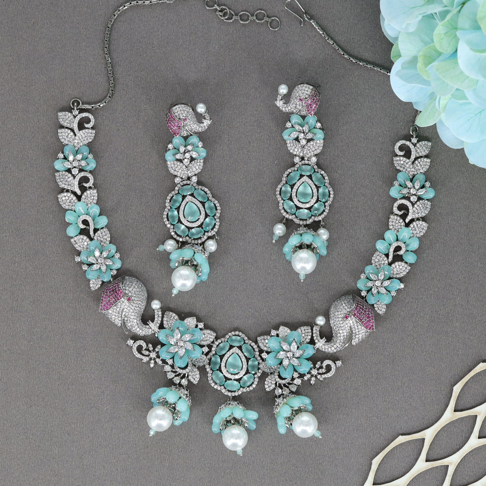 Majestic Elephant Motif Necklace with Floral Clusters and Drop Pendant Center