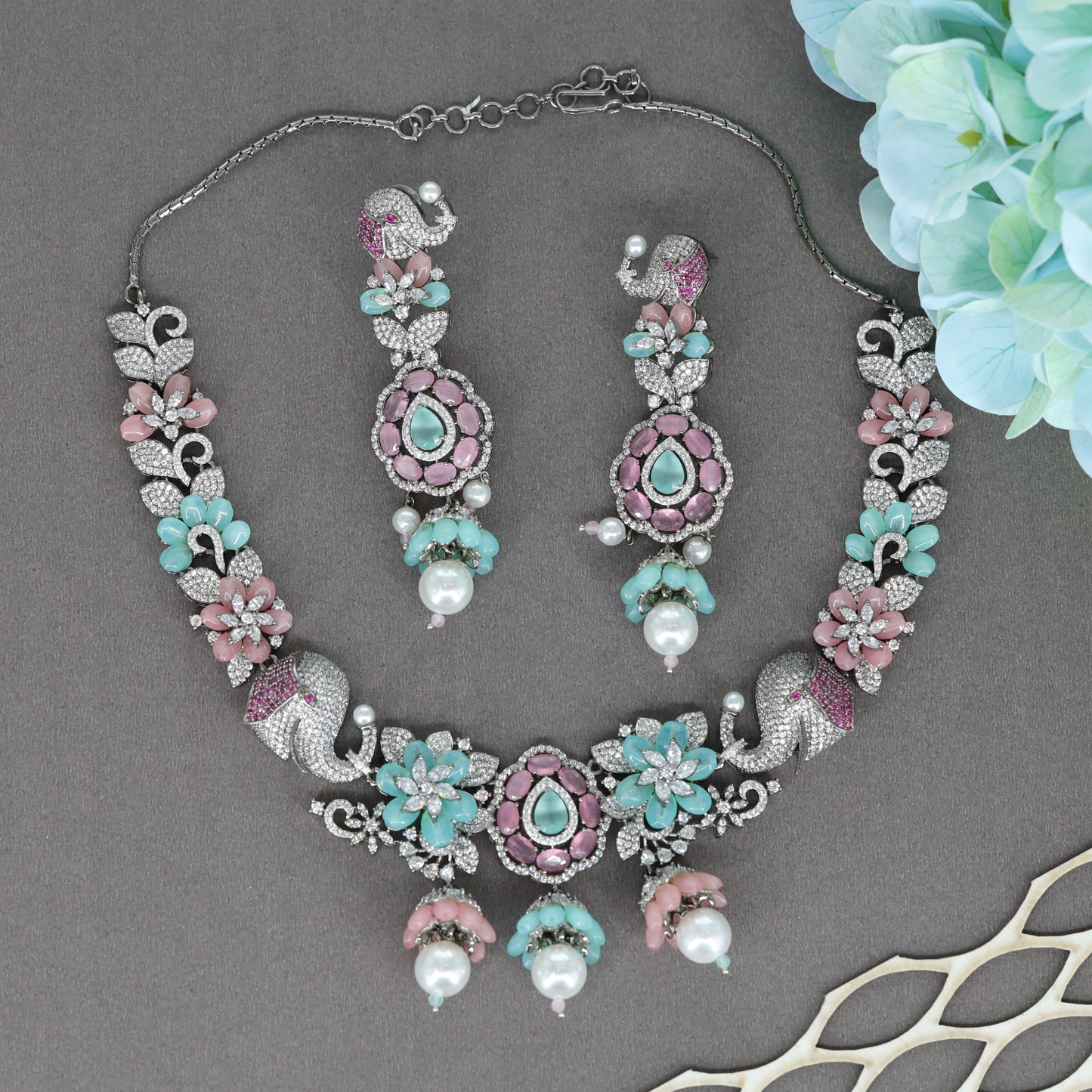 Majestic Elephant Motif Necklace with Floral Clusters and Drop Pendant Center
