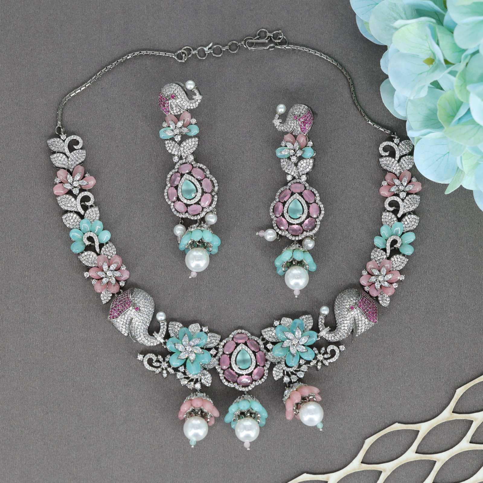 Majestic Elephant Motif Necklace with Floral Clusters and Drop Pendant Center