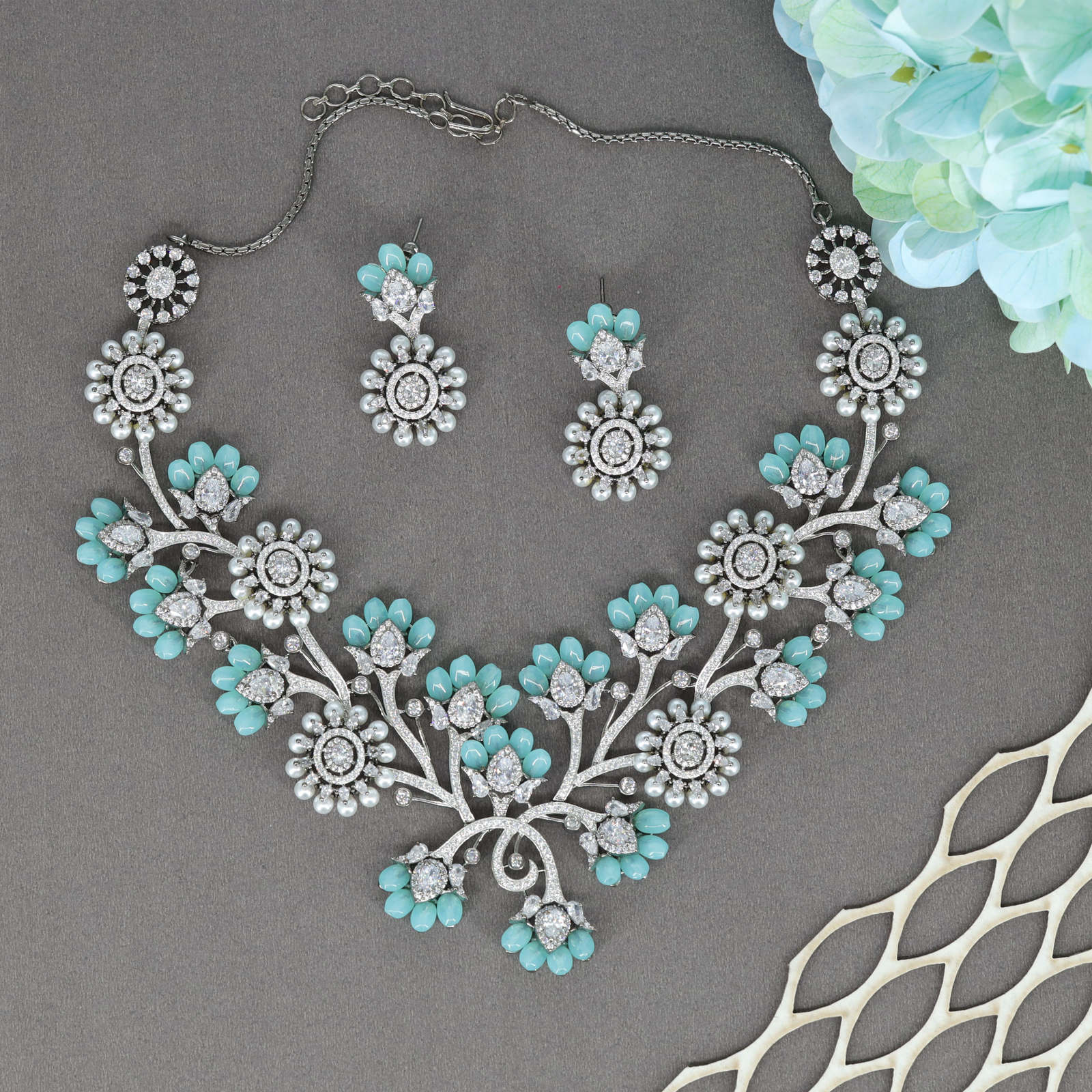 Celindra Floral Arc Necklace Set with Bloom Motifs and Decorative Crystal Sprigs