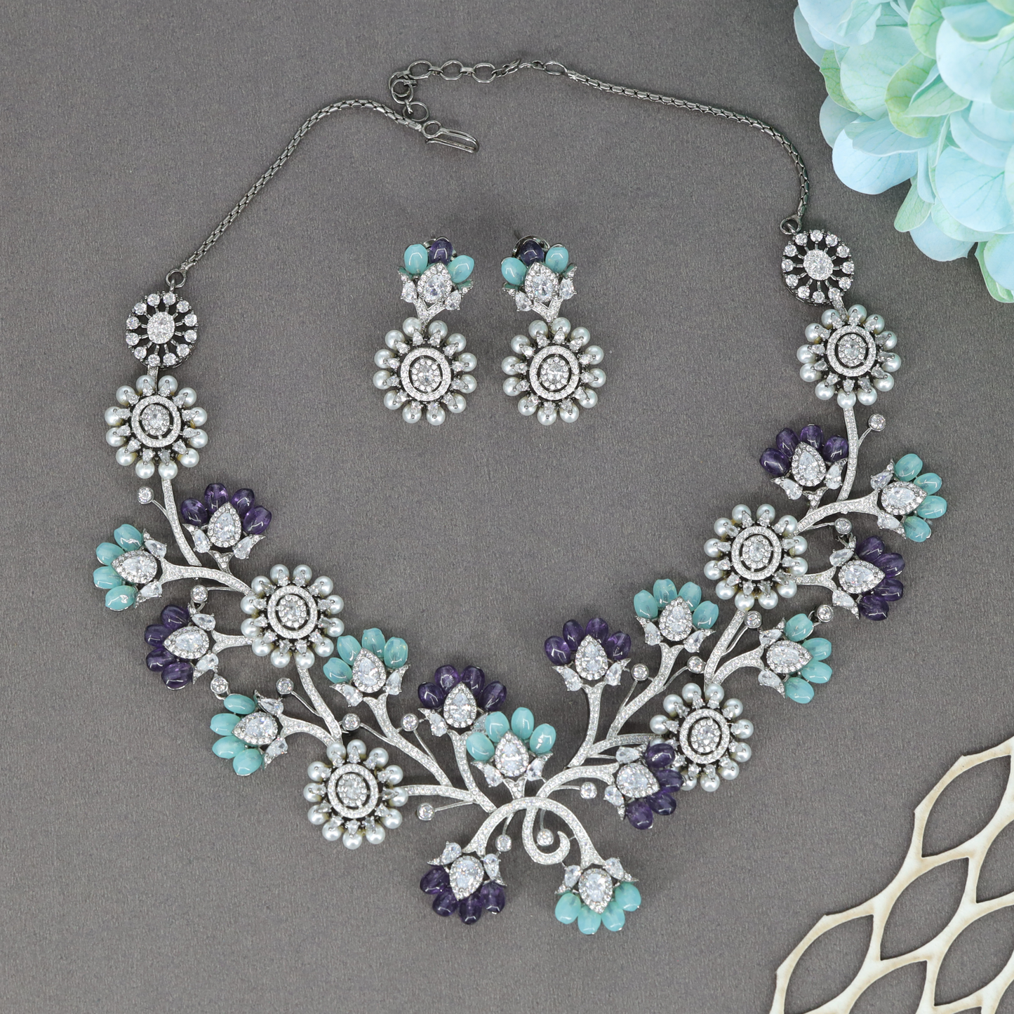 Celindra Floral Arc Necklace Set with Bloom Motifs and Decorative Crystal Sprigs