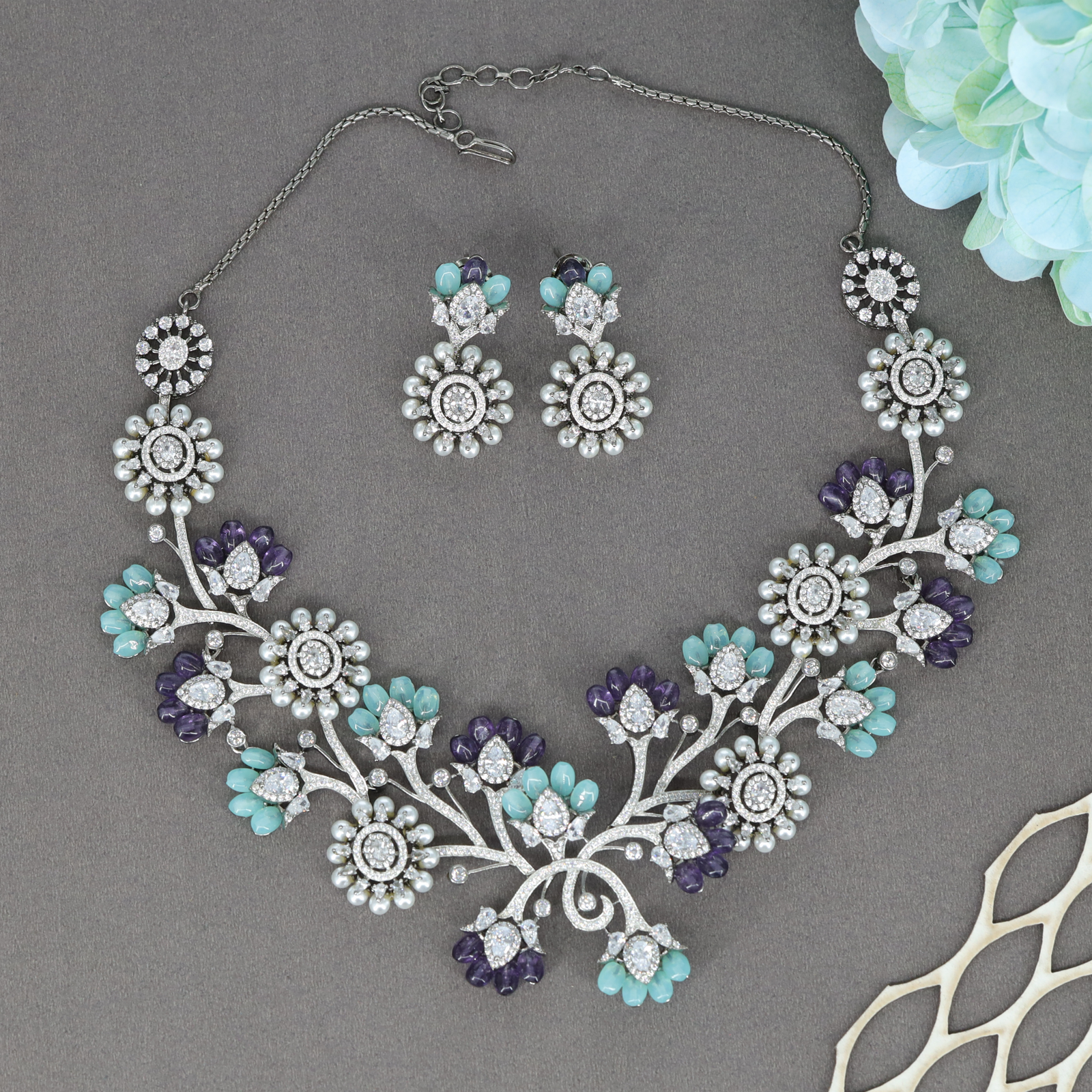 Celindra Floral Arc Necklace Set with Bloom Motifs and Decorative Crystal Sprigs
