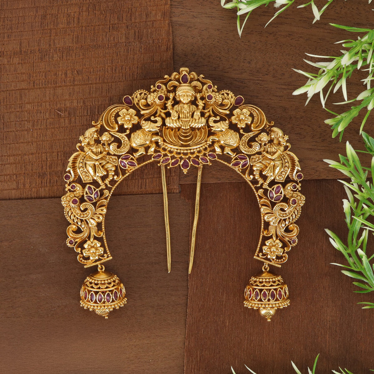 Antique Lakshmi arch with intricate floral detailing and traditional bells