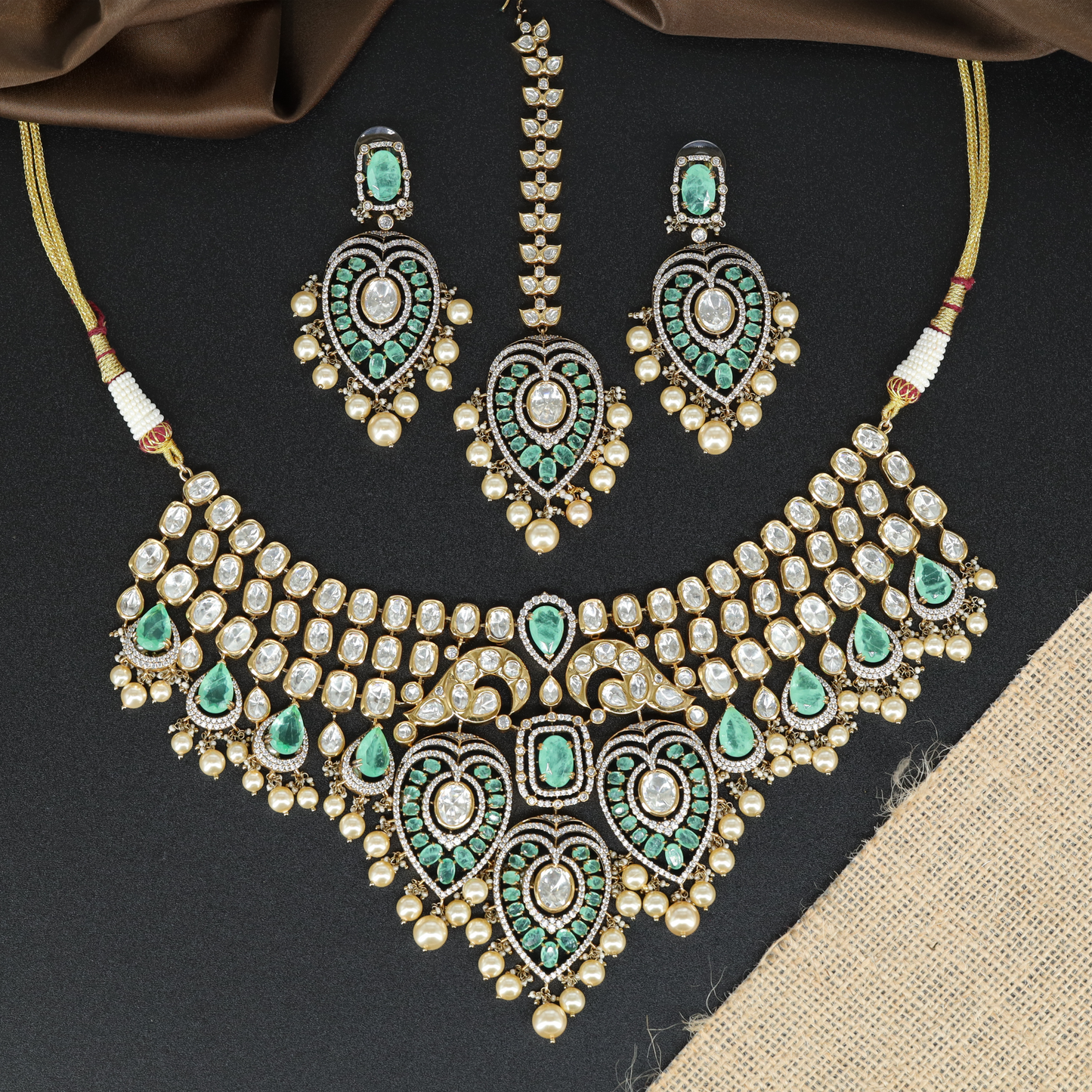 Ornate Layered Necklace with Repeating Motifs and Central Drop Arrangement